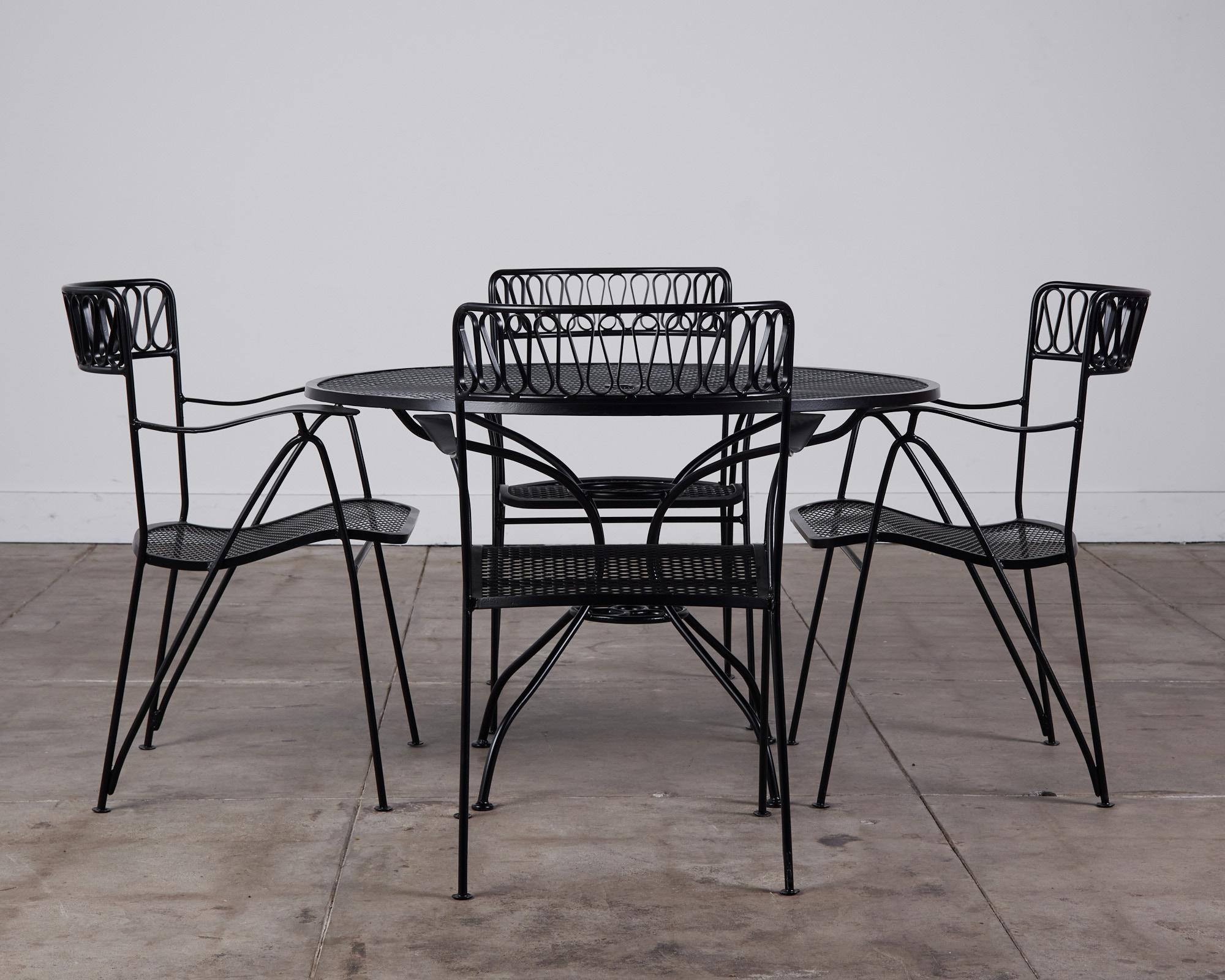 Patio set by Maurizio Tempestini for John Salterini, USA, c.1950s. This set consists of a round dining table and four wrought iron armchairs with a ribbon detail. This set has been fully restored and newly powder coated.

Tempestini was a