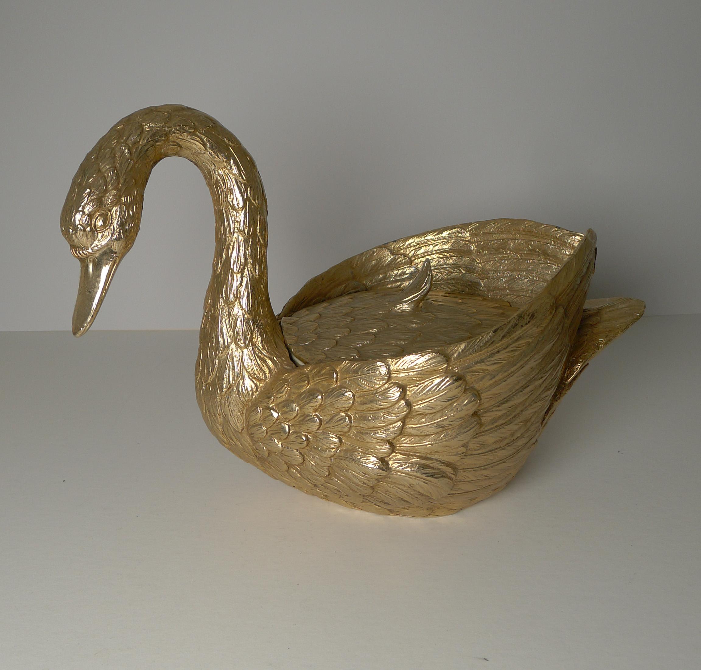 A magnificent and highly collectable Swan ice bucket and much rarer in the gilded gold finish than the more commonly seen silver colour.

The interior liner is the original and in excellent condition without damage. Signed on the underside, dating