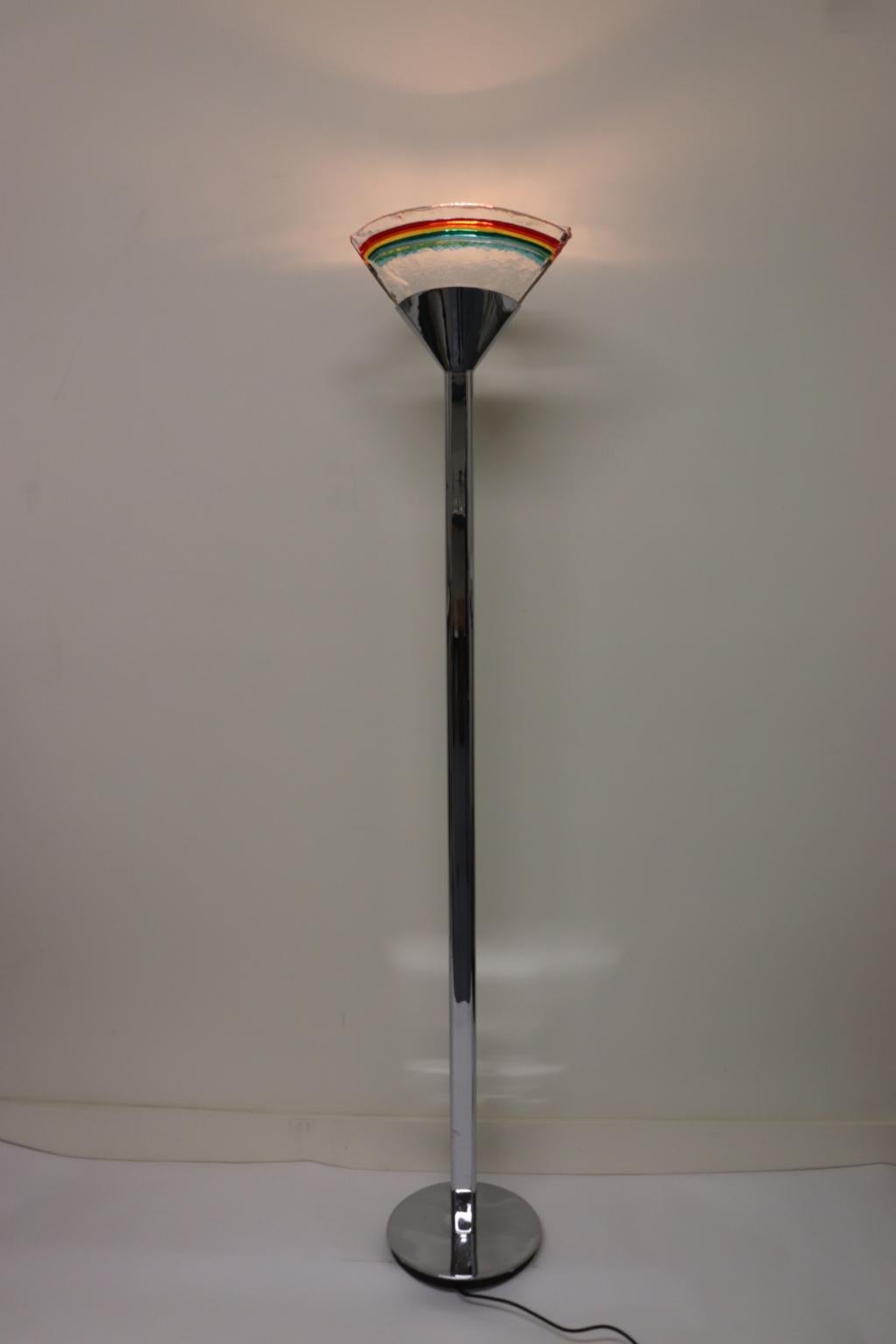 Italian floor lamp Murano hand cast curved clear glass with rainbow colors. Mounting: polished chrome metal.
The 