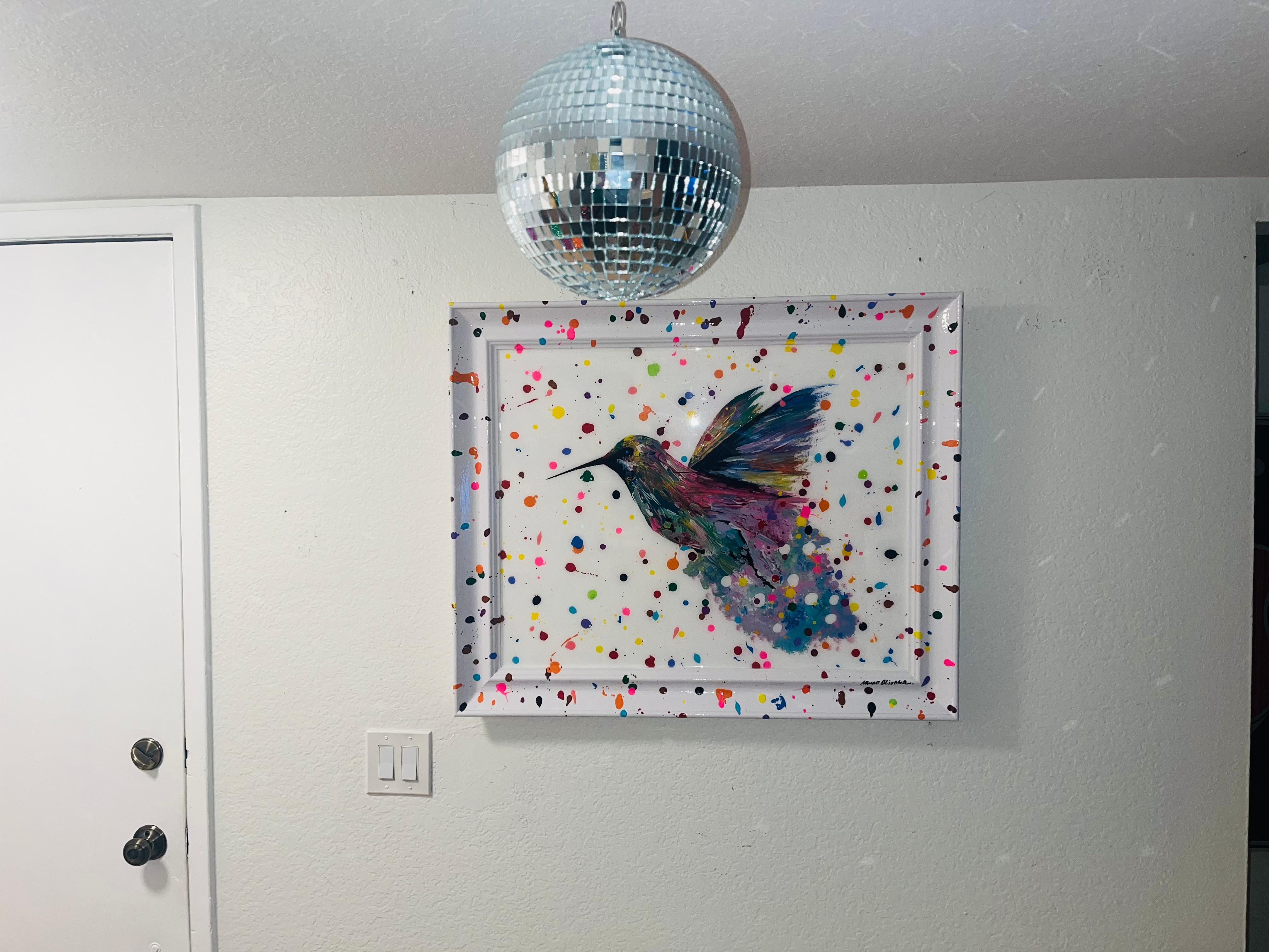 Fenix Hummingbird has been in the artist's mind for a while. It finally came to life.

The artist wanted to make something very colorful as the Hummingbirds splashing paints all over the piece including the frame. The result is this fun and colorful