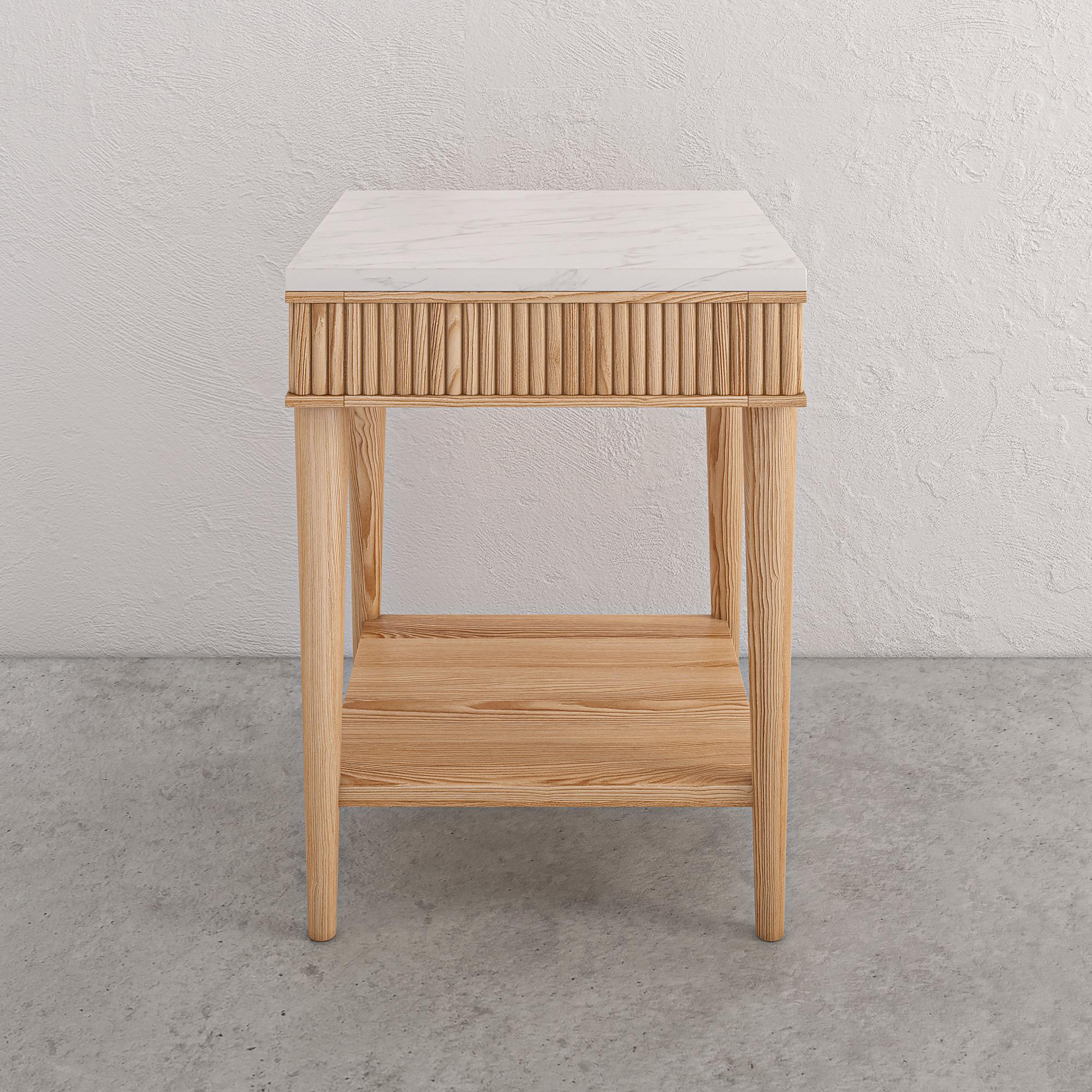 The Mausam bedside table features a delicate reeded detail and is available with either a timber, solid white or solid black marble top. A practical and versatile side table. The design provides a hint of style and minimalism. The design combines 2