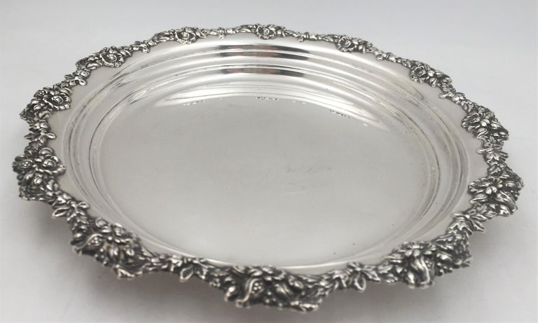 Mauser, sterling silver, early 20th century platter in exquisite Art Nouveau style with motifs such as flowers and pomegranates adorning the rim. It measures 13 1/4'' in diameter by 1 1/2'' in height, weighs 28.3 troy ounces, and bears hallmarks as