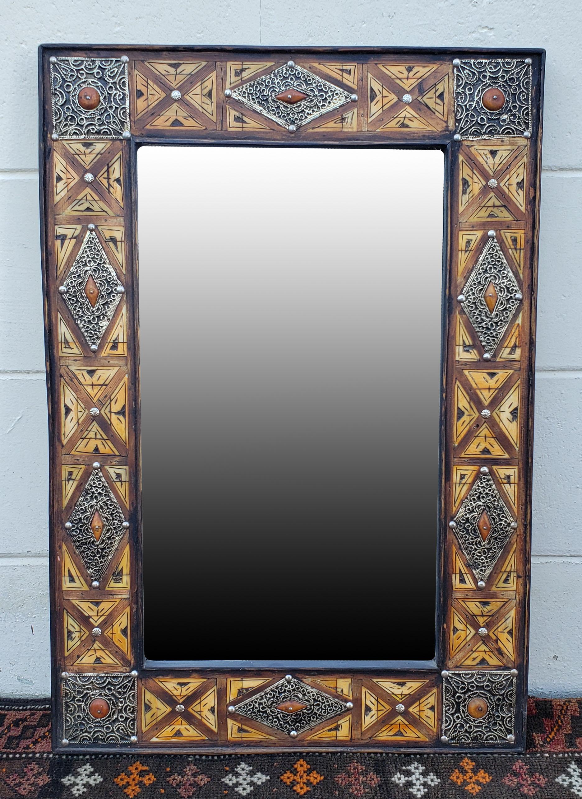 Medium size metal inlaid and camel bone Moroccan mirror. Made in the city of Marrakech. Rectangular shape measuring approximately 27