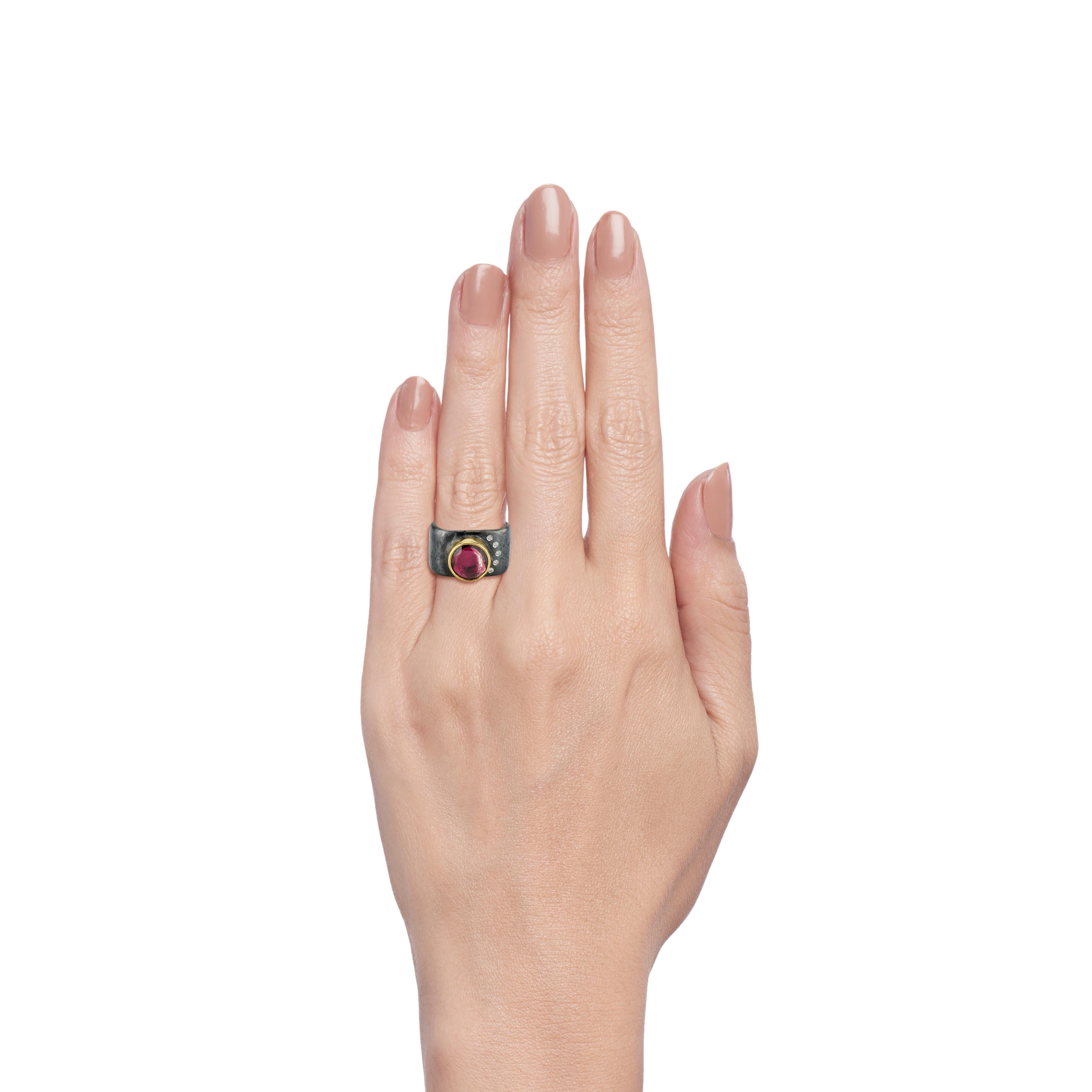 This contemporary take on a cocktail ring consists of a 2.5 carat rose cut mauve tourmaline framed in a 22 karat yellow gold bezel.  The white melee diamonds (0.075 total carat weight) are set in the 12mm wide band following the curvature of the