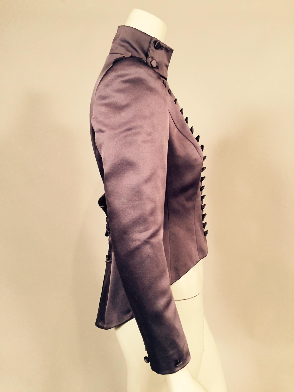 Mauve silk satin enhances the Victorian look of this very contemporary jacket designed by Maggie Norris Couture in New York City. The jacket has a high collar, sixty hand covered silk buttons, countless embroidered French knots, epaulets and avery