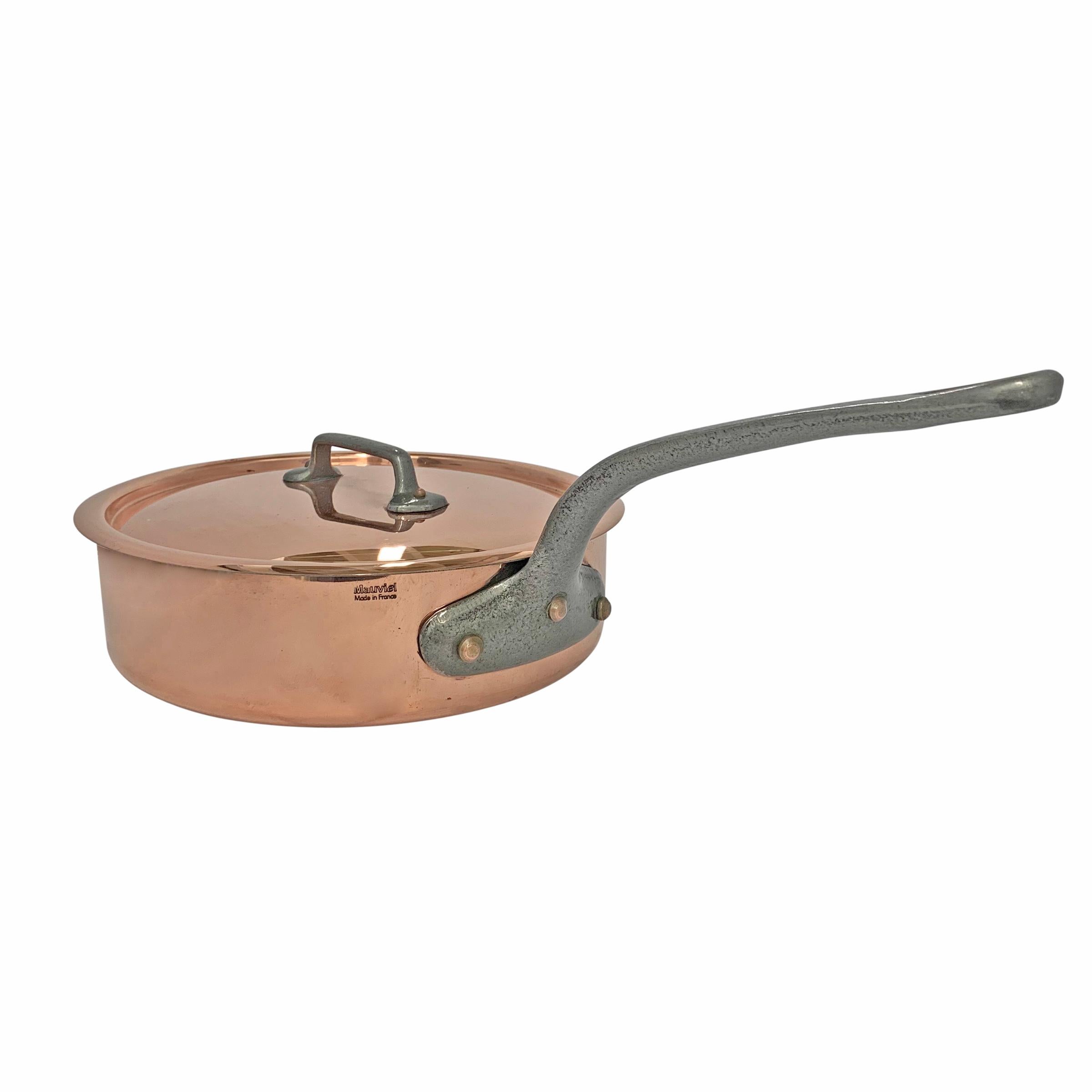 A mid-20th century French 3 mm thick copper sauté pan with lid, iron handles, and a tin lining. Marked 