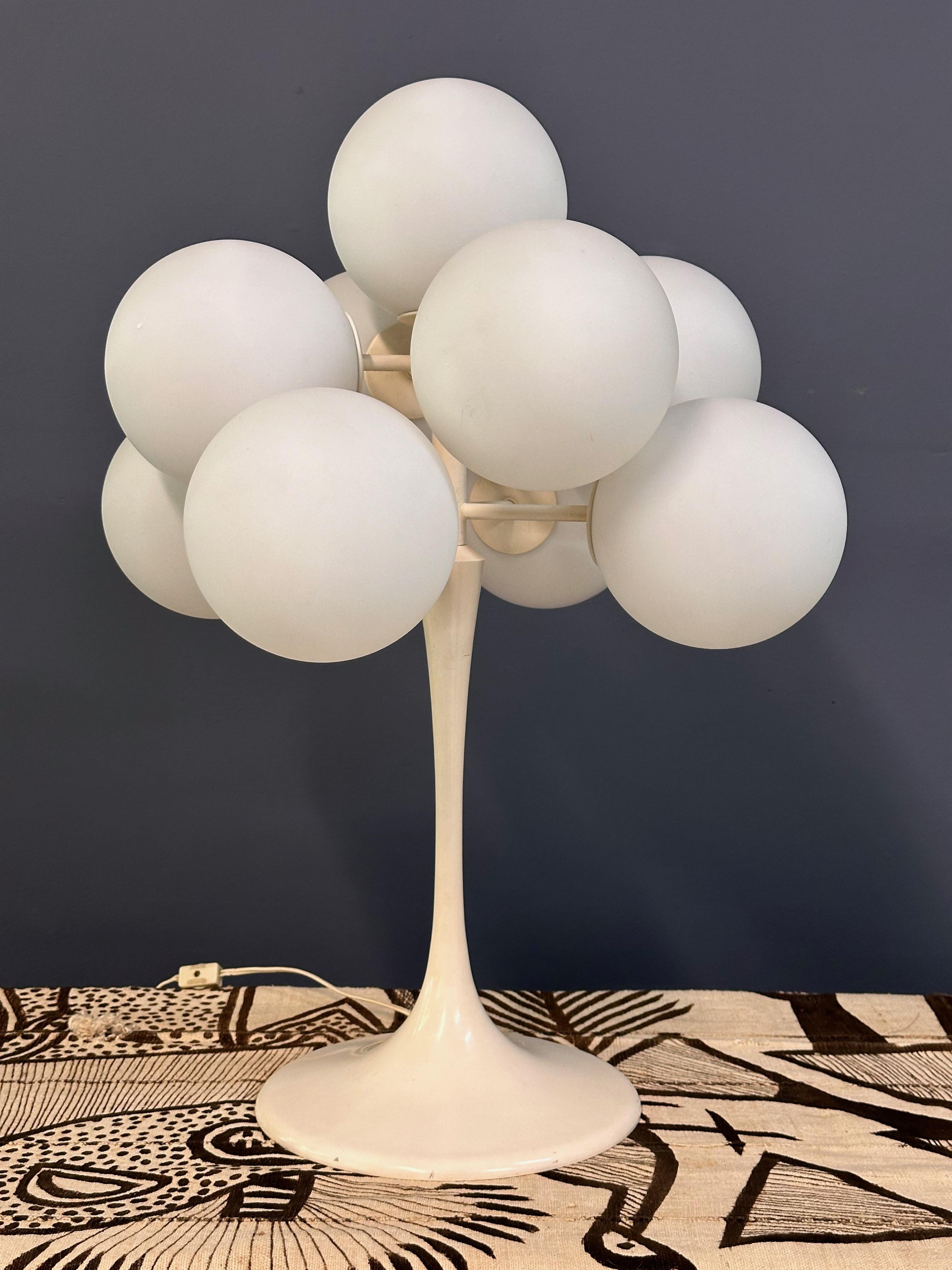 The Max Bill 9 White Opaline Globe Table Lamp, a timeless addition to any mid-century inspired space. Crafted with precision and designed by Max Bill, this lamp features 9 stunning white opaline globes that radiates a soft, ambient light. Elevate
