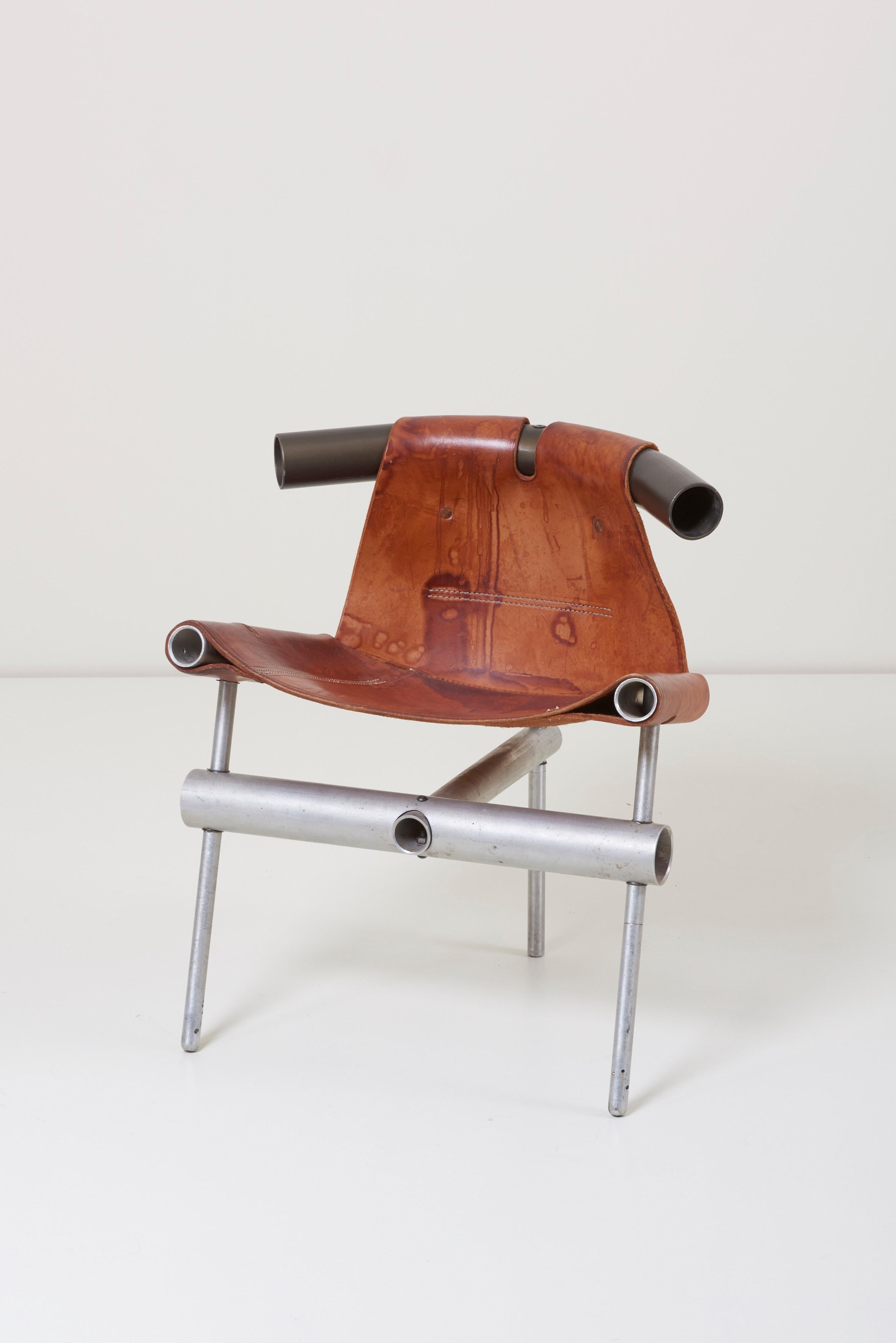 A low prototype lounge chair designed by Max Gottschalk. The chair is made of metal pipes and thick brown natural leather.



 