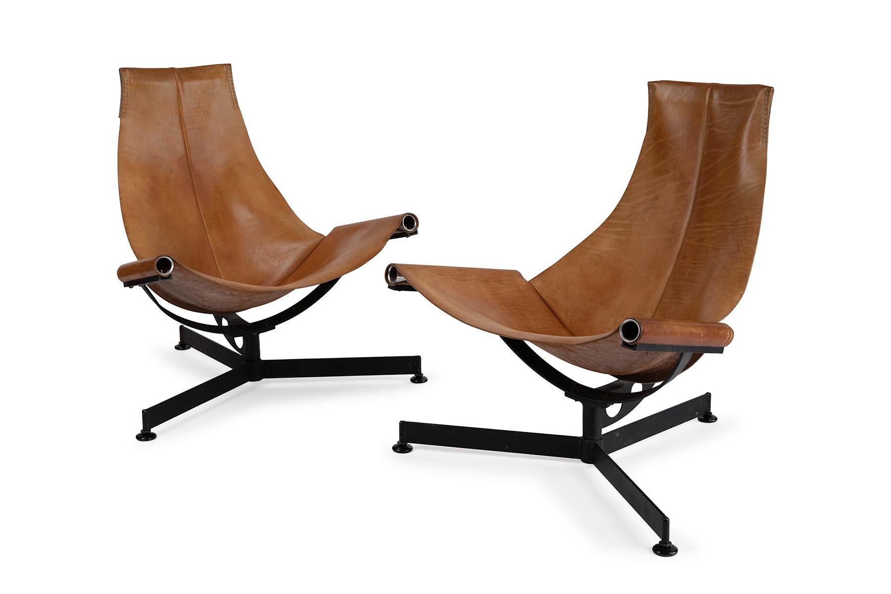 Early 1970s patinated saddle leather sling chairs with graceful iron frames by Tucson, Arizona designer Max Gottschalk. These all original examples are priced as a pair.