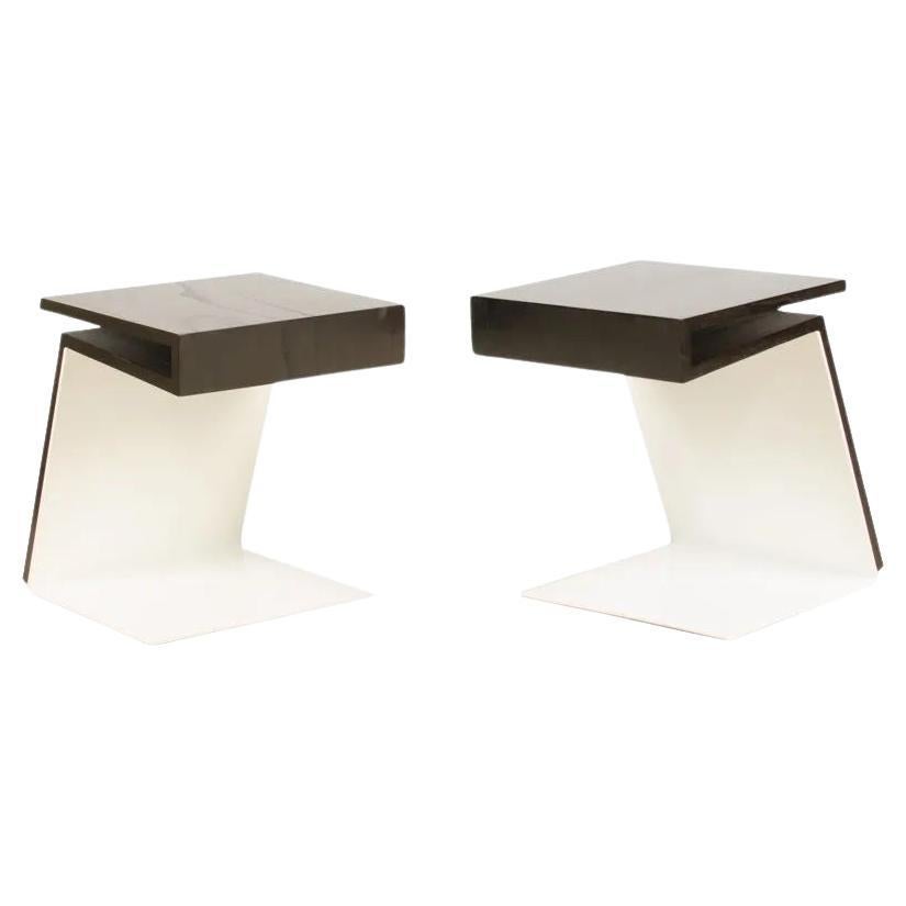 A pair of side tables. Solid teak table top with ebonized finish, with white powder-coated solid bent steel base.

Measures: H 18.5