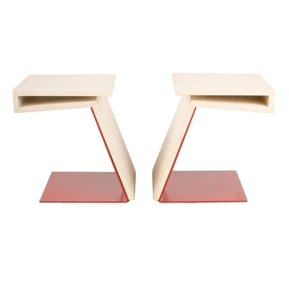 A pair of cantilevered side tables. Solid teak table top with whitewash finish, with red powder-coated solid bent steel base. 

Measures: H 18.5
