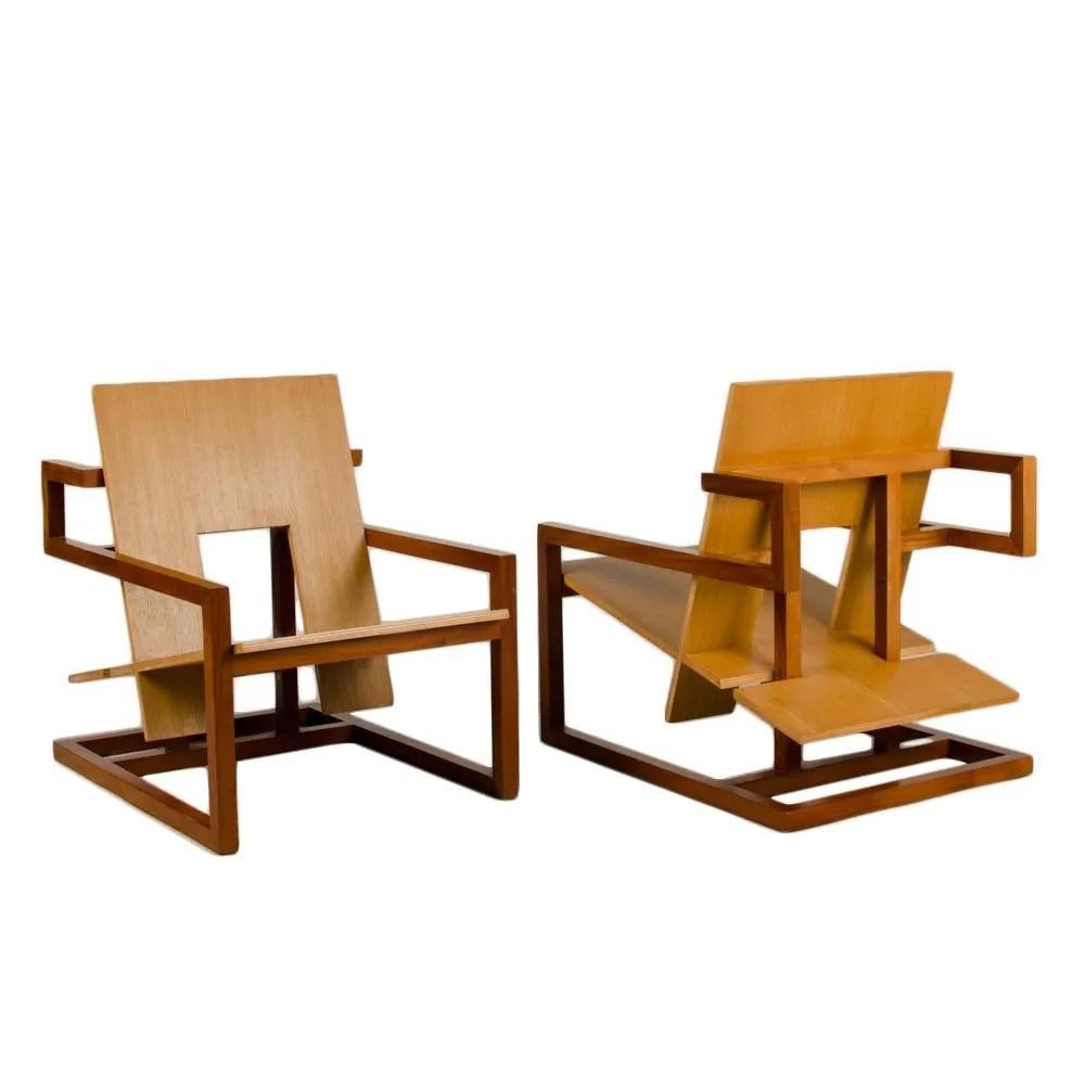 A pair of modern arm chairs constructed of a mahogany frame with natural finish and oak veneered wood seat with exposed edges

Measures: D 35. in x W 26.4 in x H 33 in

Maximilian Eicke having founded his minimalististic design studio Max ID NY,