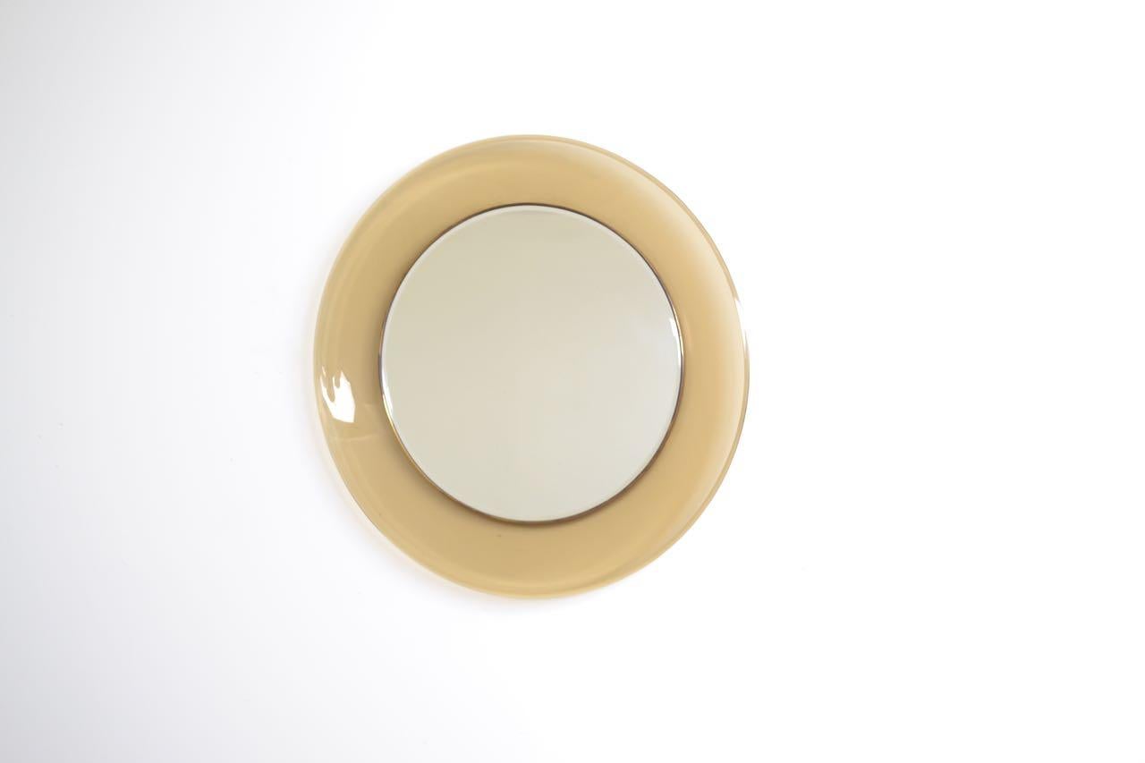 Max Ingrand designed '1669' mirror for Fontana Arte.
Circular mirror with a concave glass surround and beveled detail to the outside edge, lacquered brass internal frame showing signs of ware to the lacquer.
Mirror stamped on the back 1967.