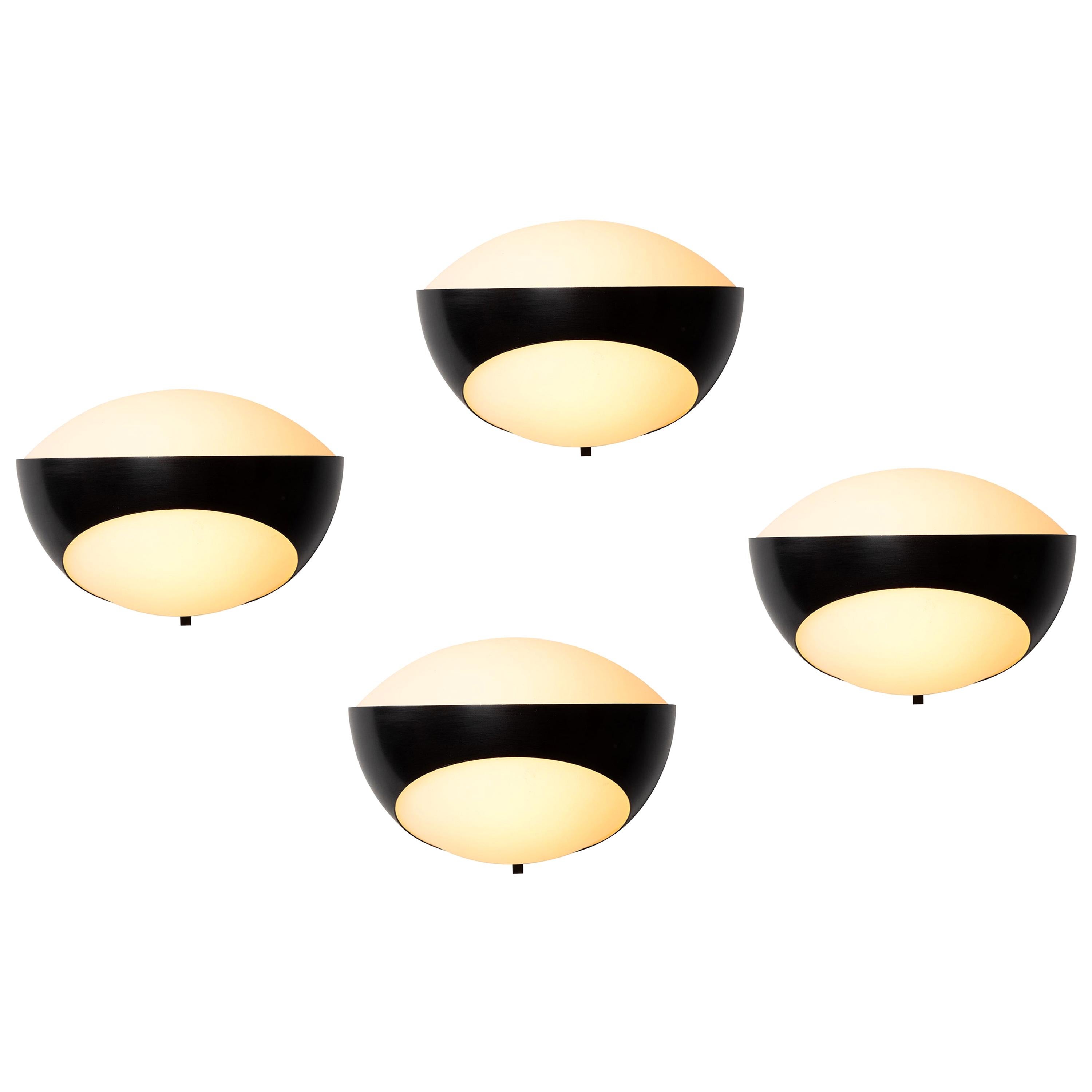 Rare 1960s Max Ingrand '1963' sconces for Fontana Arte. Executed in opaline glass, black painted metal and brass, Italy, circa 1960s. A highly sculptural design by one of the greatest masters of lighting, these exceptional sconces exude elegance and
