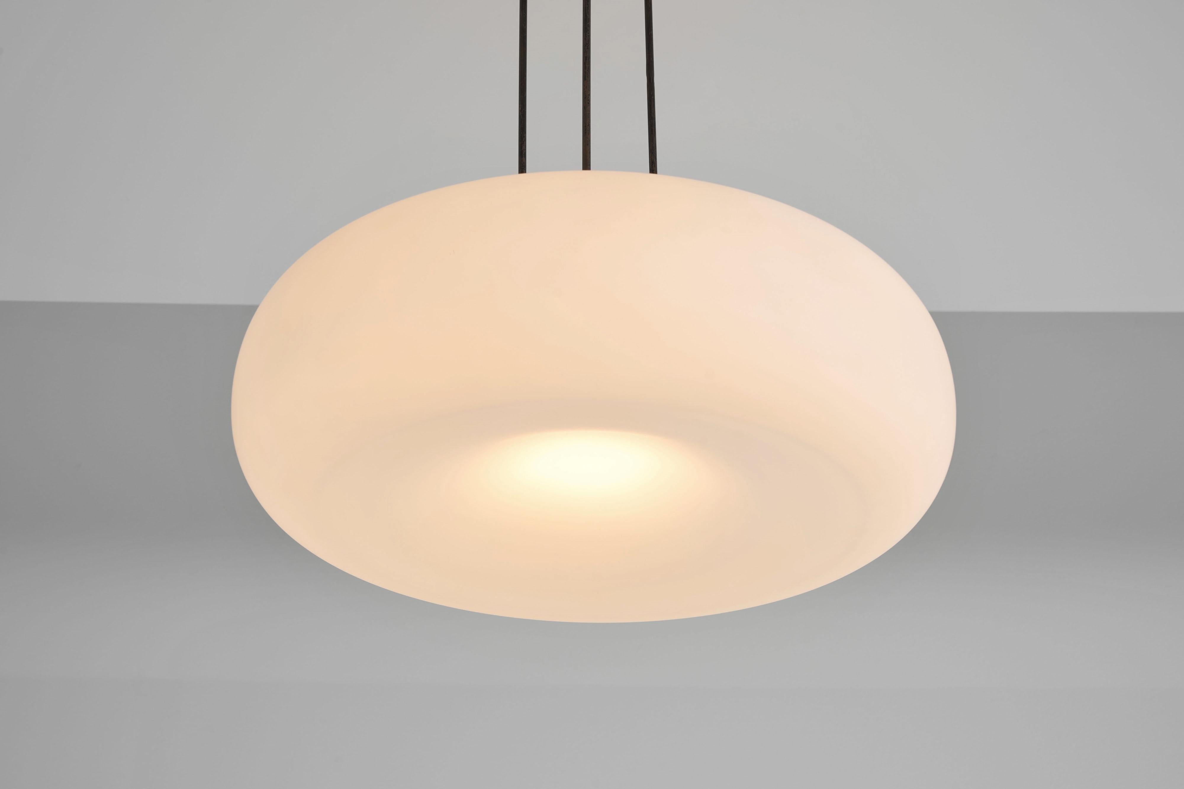 Unique ceiling light designed by Max Ingrand for Fontana Arte. It features a matt milk glass shade with a stunning inner blown shade, resembling a planet in its appearance, a really unique and atmospheric sight. The ceiling cap is crafted from