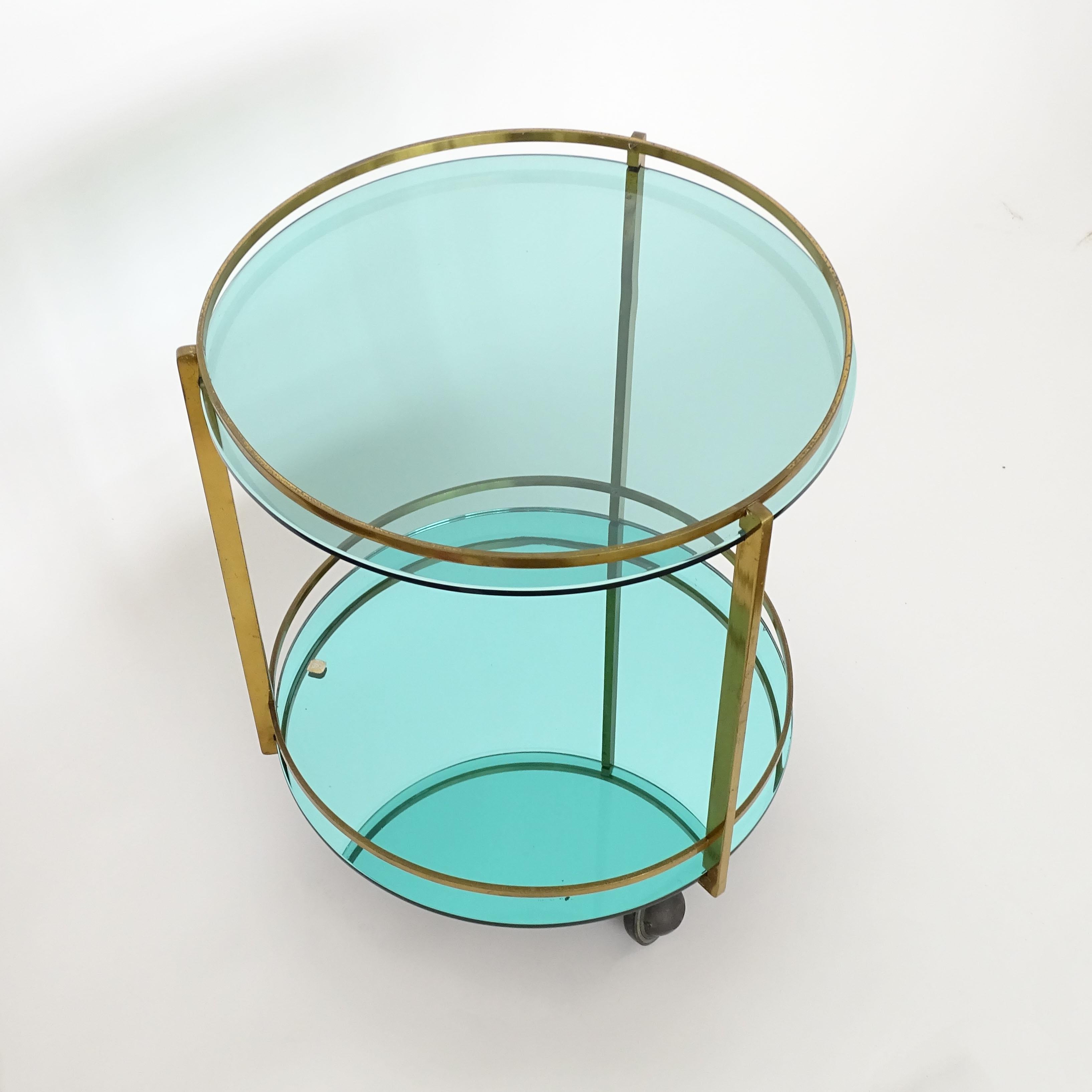 Splendid and rare Max Ingrand Ber Cart for Fontana Arte.
Italy 1960s
All original glass parts are in the classic Fontana green.
The base glass is green mirrored, and the top glass is tinted green.
The cart carries the original FA Label.
Reference: