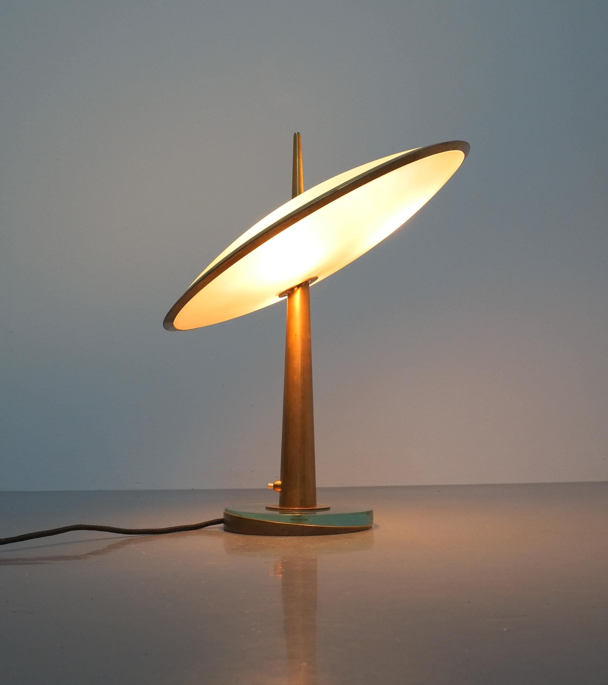 This lamp is on sale until the end of December only.

Rare max Ingrand Fontana Arte Disco Volante Mod. 1538, Italy, 1955. Formidable iconic table light with many astonishing details such as a solid brass rim connecting the 2 colored and etched blue