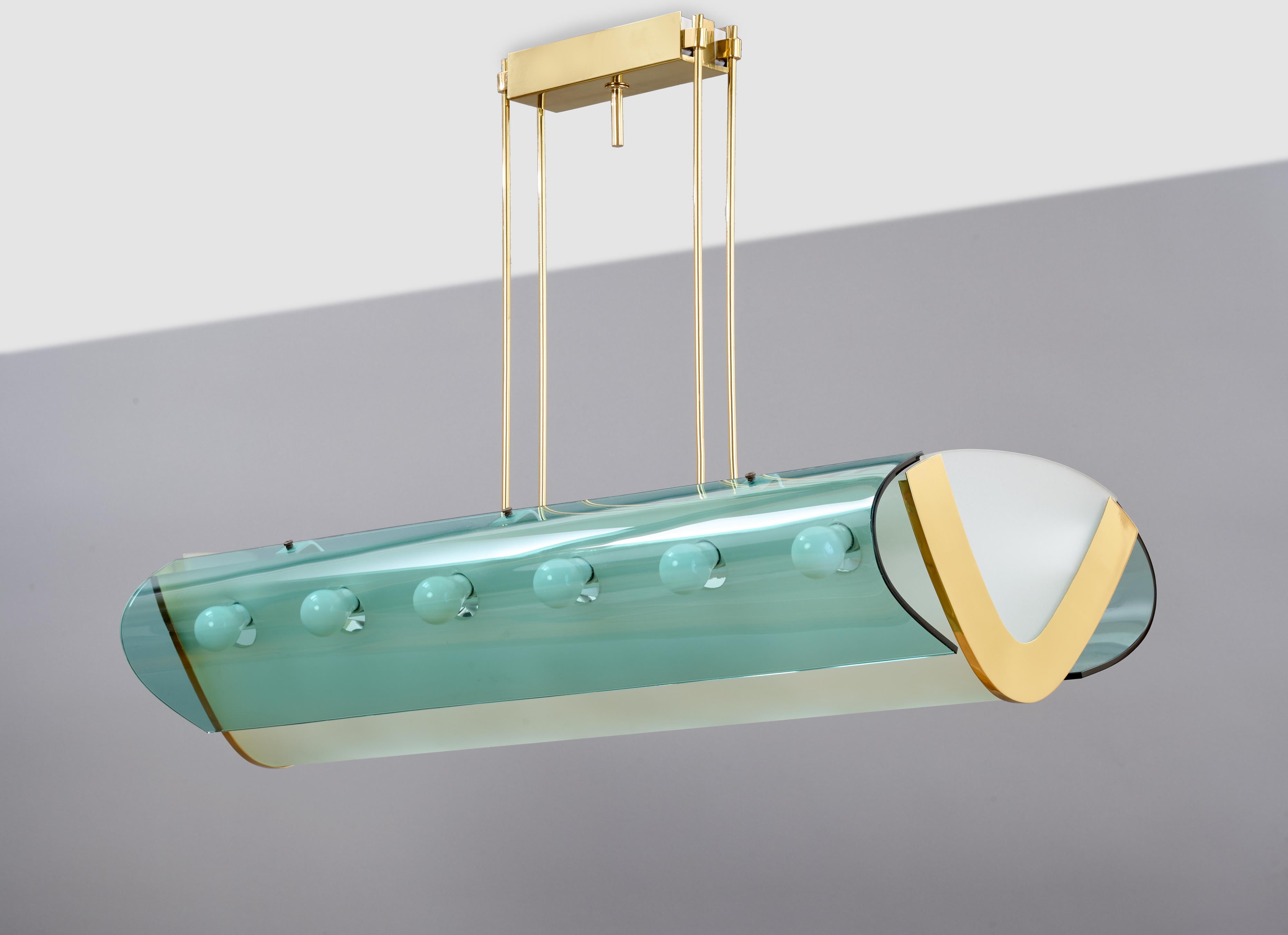 Max Ingrand (1908 - 1969) for Fontana Arte

A large and important 18-bulb pendant chandelier by Max Ingrand for Fontana Arte, oblong in shape; in frosted, clear, and colored glass with mirror-polished brass mounts. A long V-shaped body with a