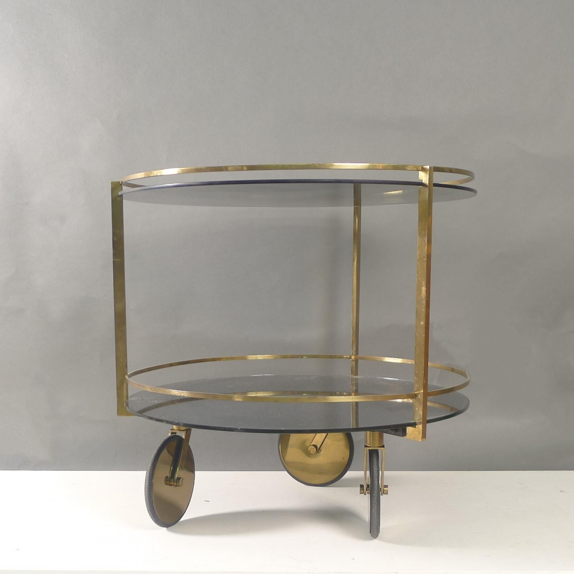 Max Ingrand
Bar Cart or Serving Trolley, model 2246
made by Fontana Arte, Milan, Italy, circa 1960
brass, smoked glass
59.5cm high, 61.5cm diameter

This stylish bar cart designed by Max Ingrand consists of two circular pieces of smoked glass within