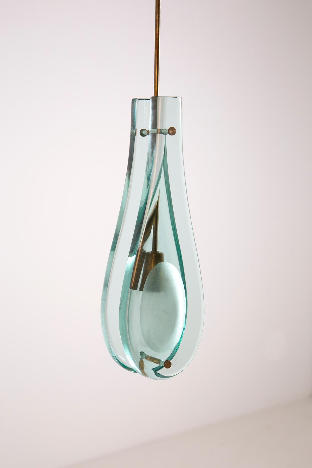 Rare pair of pendant lamps designed by Max Ingrand and produced by Fontana Arte, Italy 1962. Model No. 2259. These lamps have a brass structure and blue glass shades. Very thick glass typical of Fontana Arte. The lamps give a very nice warm light