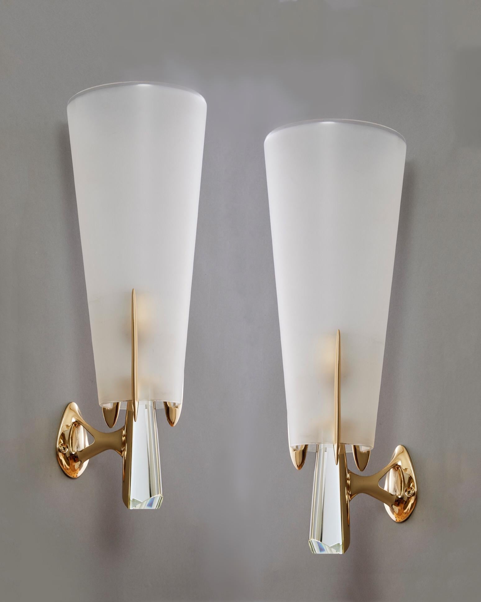 Max Ingrand (1908 - 1969)

An important pair of rare and exquisite sconces by Max Ingrand for Fontana Arte, in perfectly restored condition. Large conical shades in satin glass with a delicately beveled edge are supported by elegant trident mounts