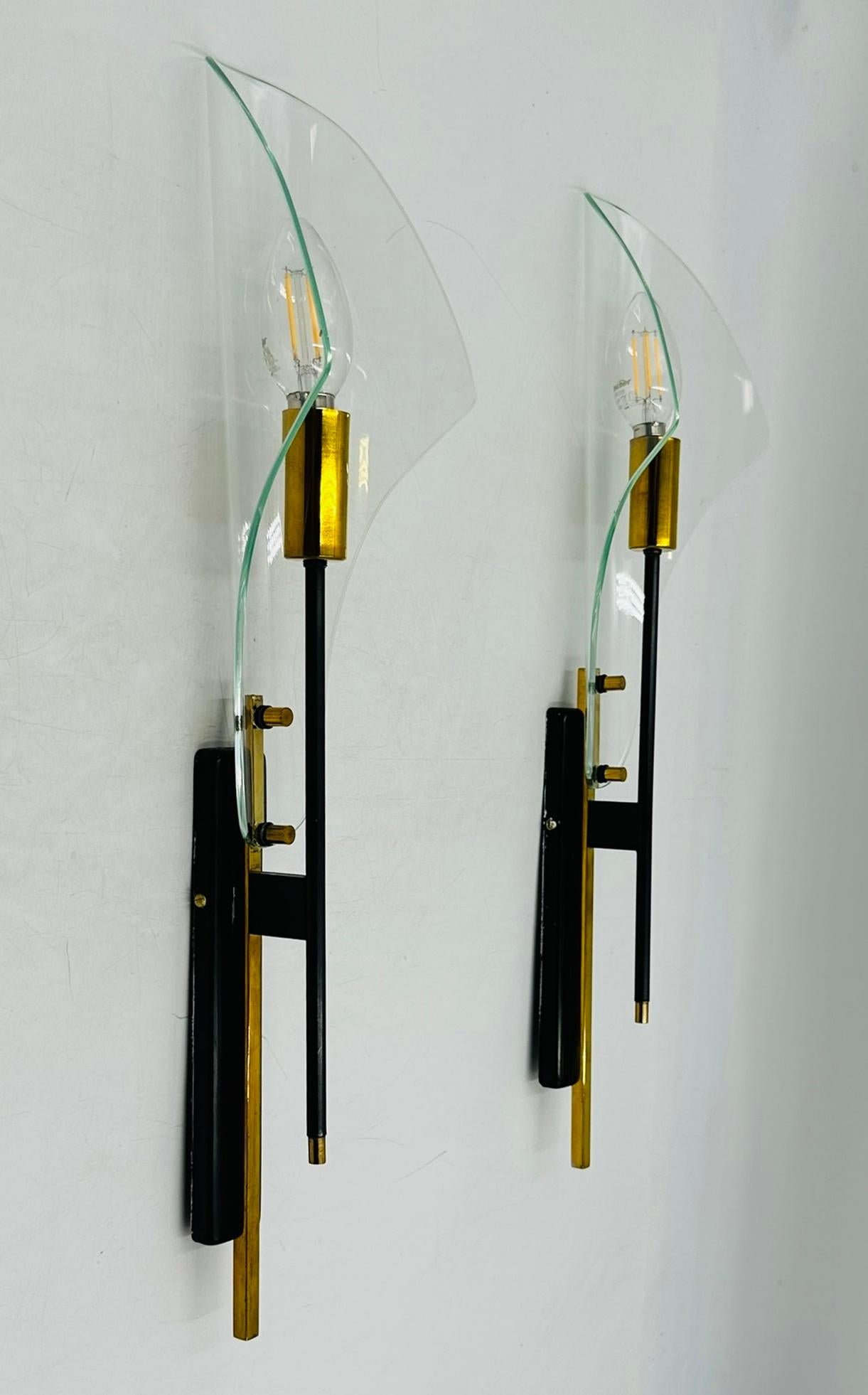 Enhance the elegance and sophistication of your space with these exquisite Max Ingrand for Fontana Arte Glass Wall Sconces, circa 1960. Crafted with meticulous attention to detail, these stunning wall lamps feature delicate glass shades and sleek