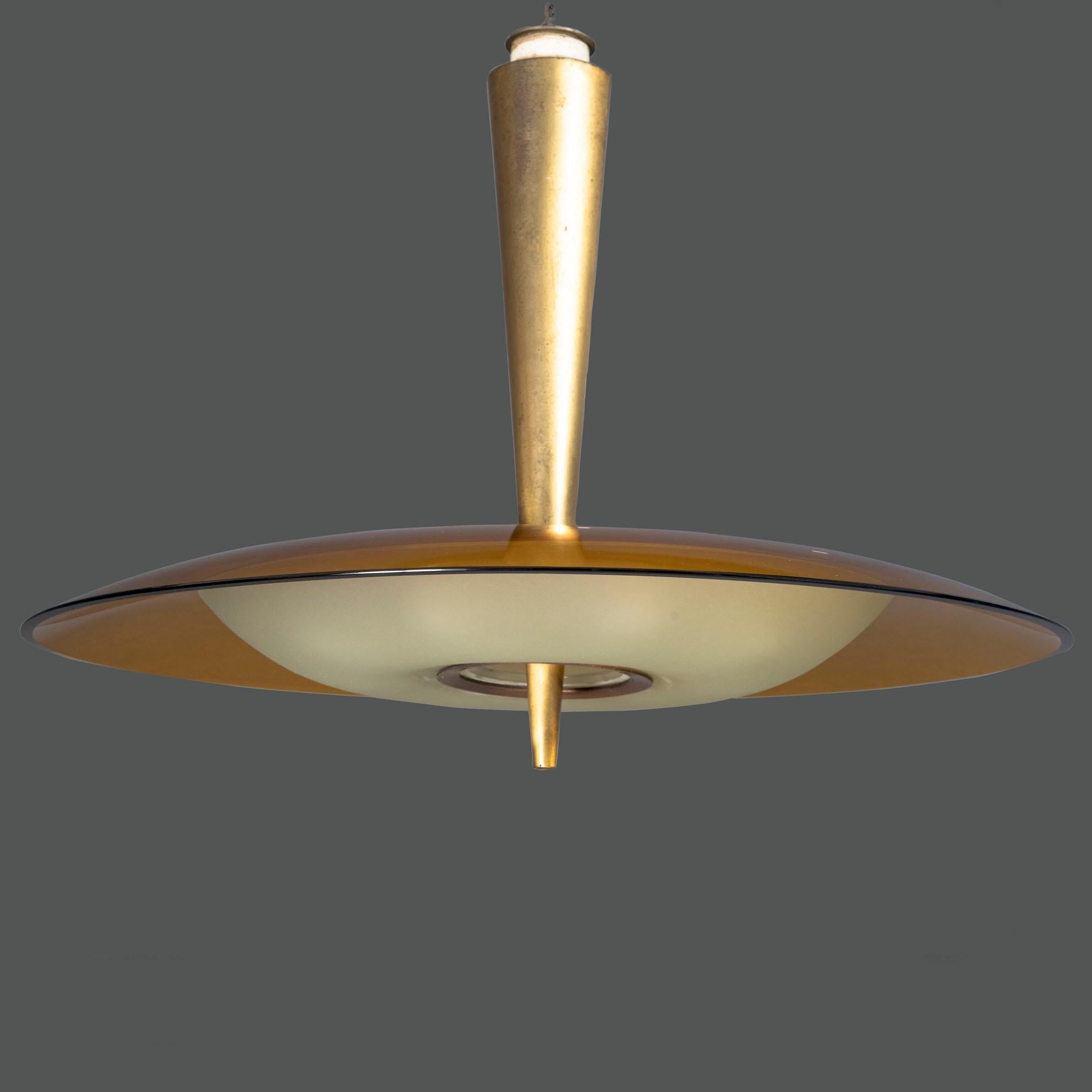 Iconic chandelier model 1462 A, made by Fontana Arte in the 1960s, designed by Max Ingrand. 
Very rare amber color
The eight candelabra sockets are masked by a frosted glass shade.
The hanging lamp is supported by a conical-shaped stem in gilded