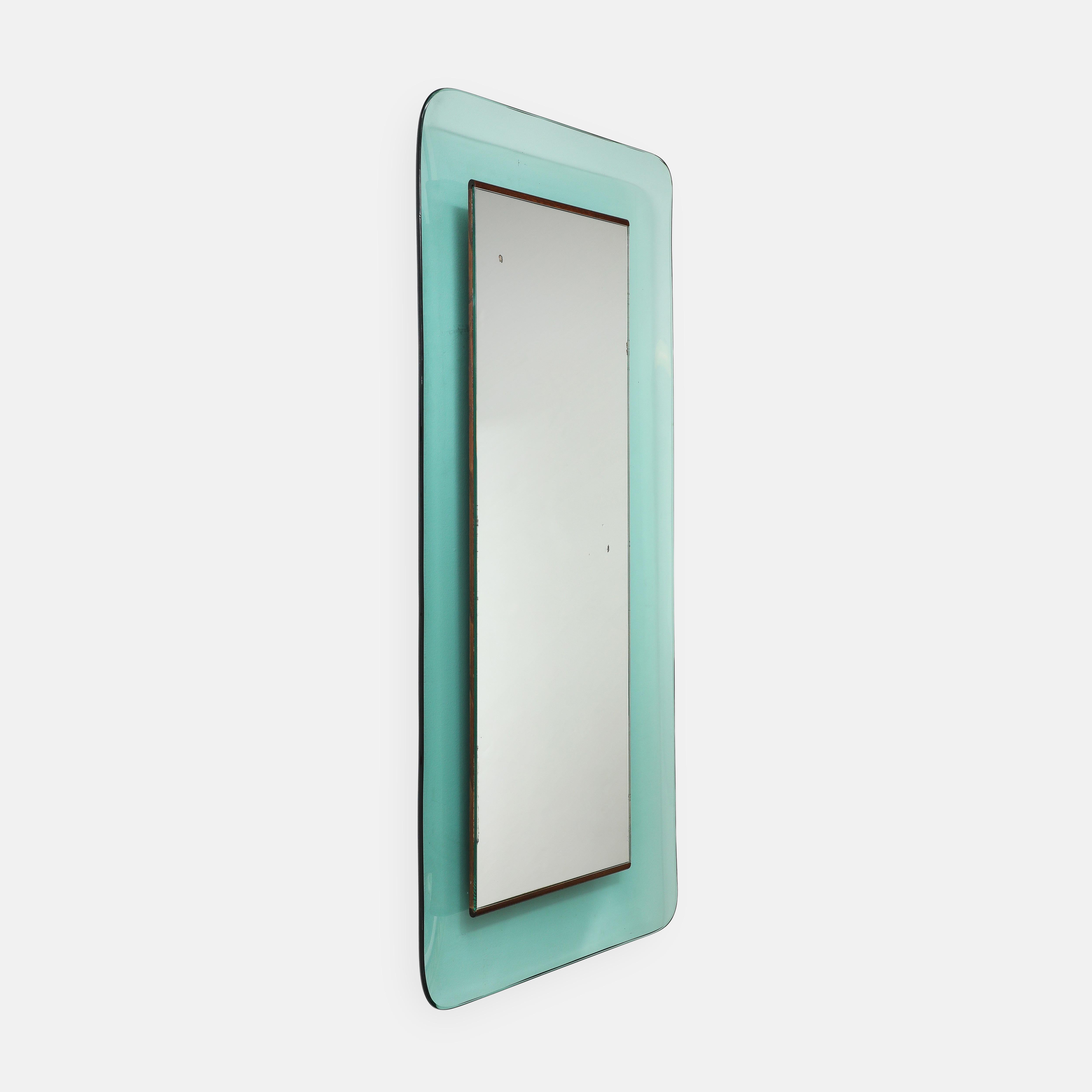 Max Ingrand for Fontana Arte large rectangular long mirror model 2273 in  colored, curved and profiled crystal glass framing mirrored glass with polished wood strips or supports on top and bottom, Italy, circa 1956. This elegant mirror with its