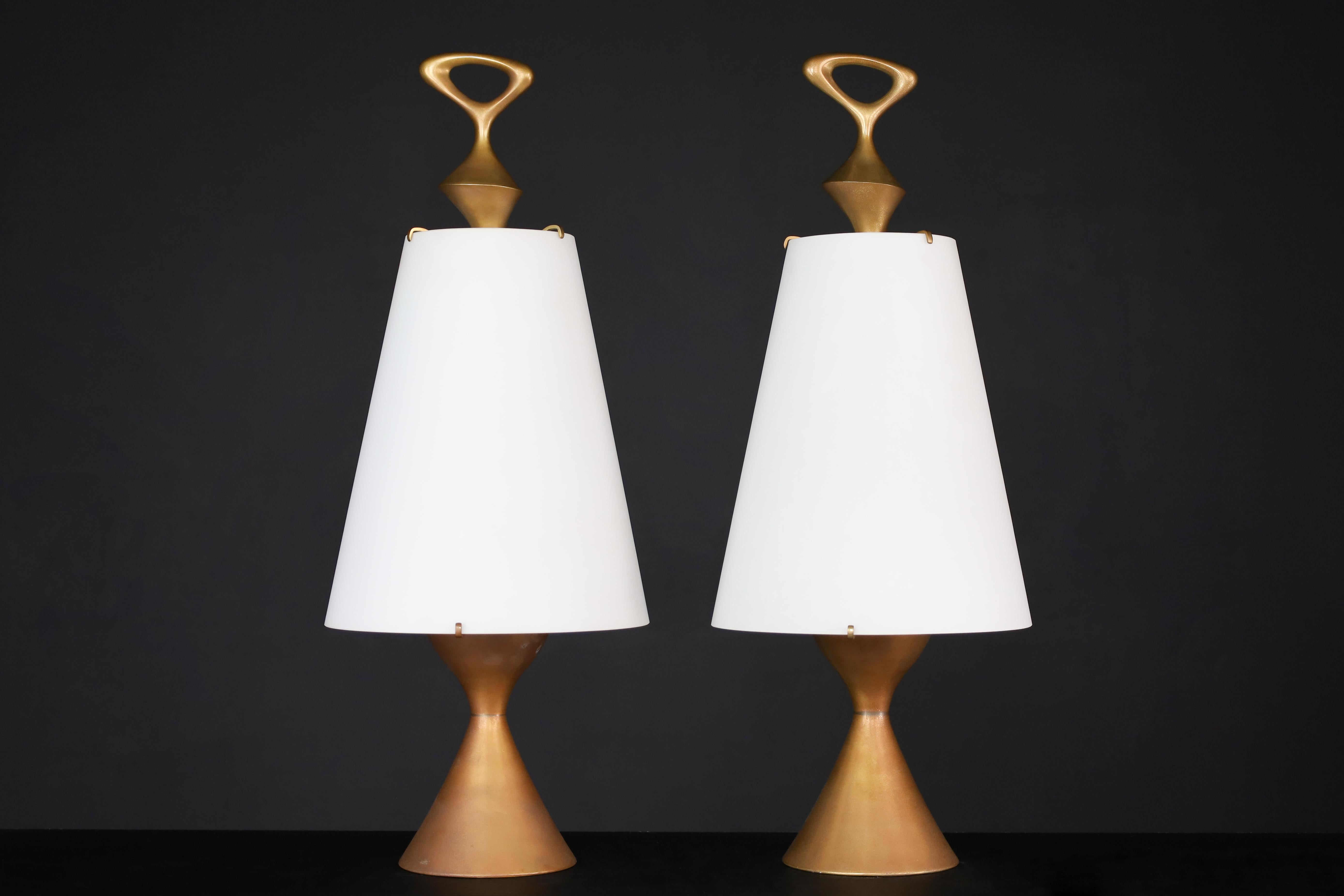 Max Ingrand for Fontana Arte pair of two patinated  Brass table lamps Italy 1956.

Max Ingrand designed a pair of exceptional table lamps for Fontana Arte in Italy in 1956. These lamps have a stunning hourglass-shaped base made of patinated brass