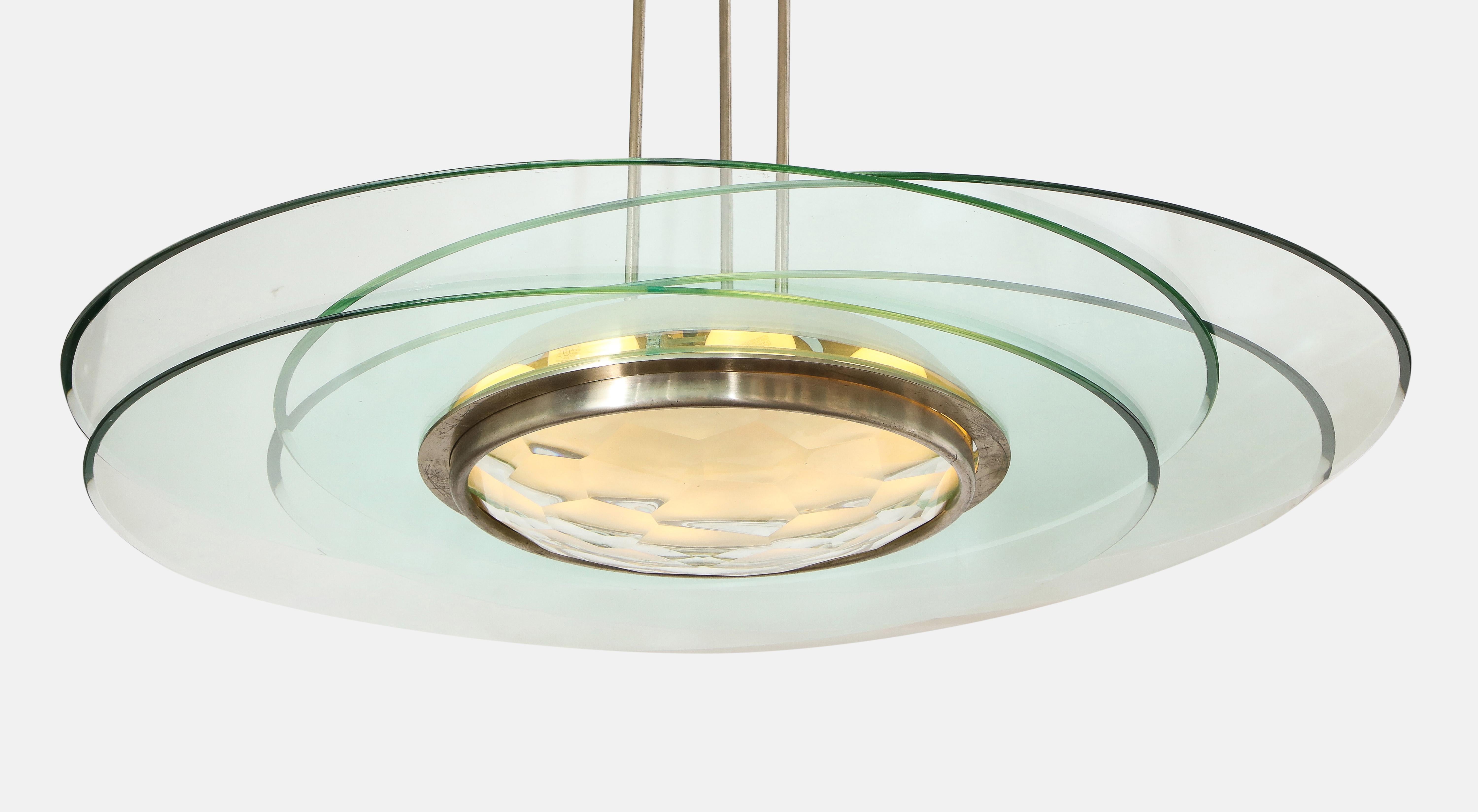 Max Ingrand for Fontana Arte important and rare sculptural chandelier model 2127 consisting of four clear crystal discs with beveled edges that radiate around a nickel-plated brass structure with large central faceted and curved cut glass 