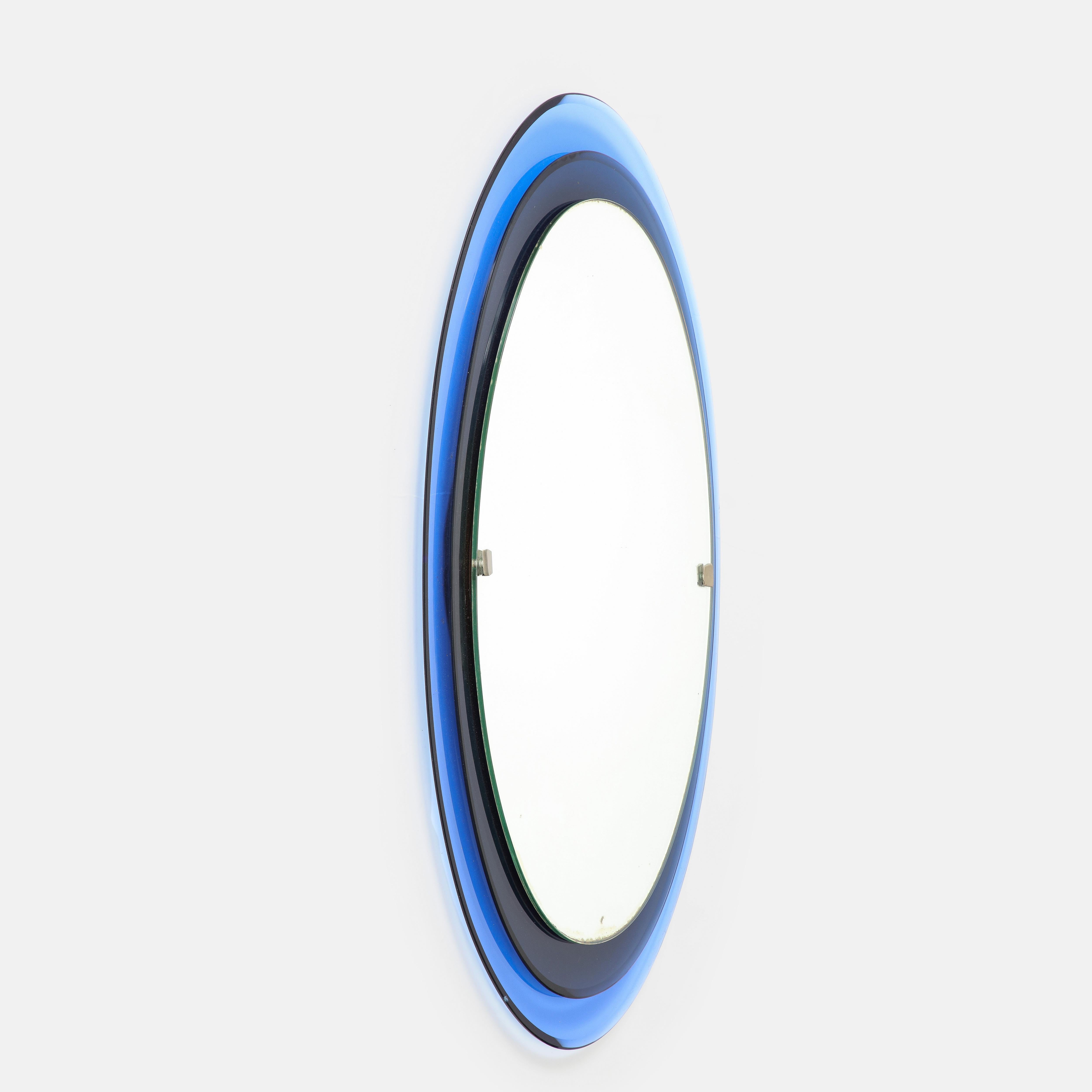 Max Ingrand Fontana Arte rare oval crystal mirror model 2046 consisting of two tiers of colored, curved and beveled glass framing mirrored glass with nickel-plated metal mounts, Italy, 1960s. Manufacturer’s label Fontanit on wood backing of