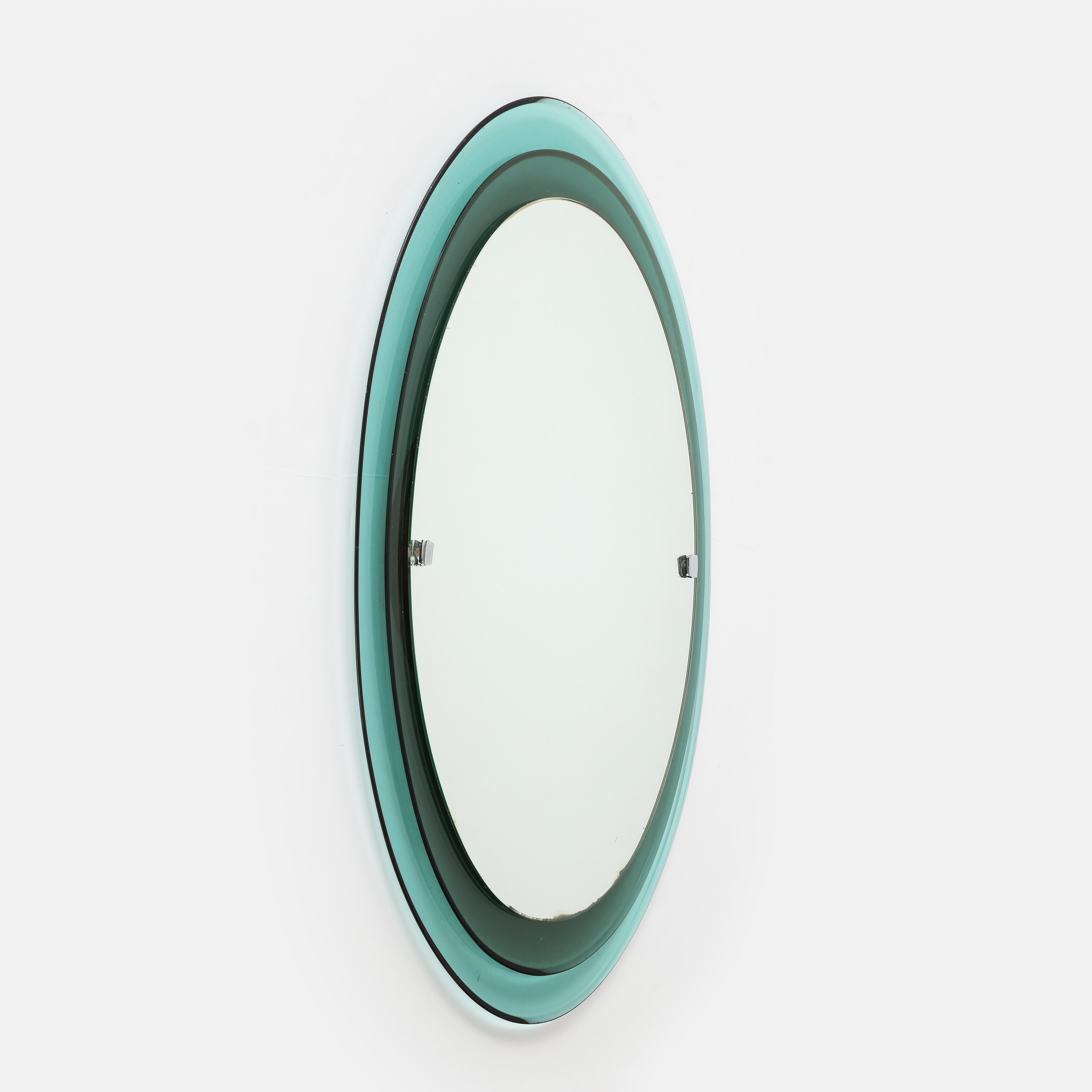 Max Ingrand Fontana Arte rare oval crystal mirror model 2046 consisting of two tiers of colored, curved and beveled glass framing mirrored glass with nickel-plated metal mounts, Italy, 1960s. Manufacturer’s label Fontanit on wood backing of