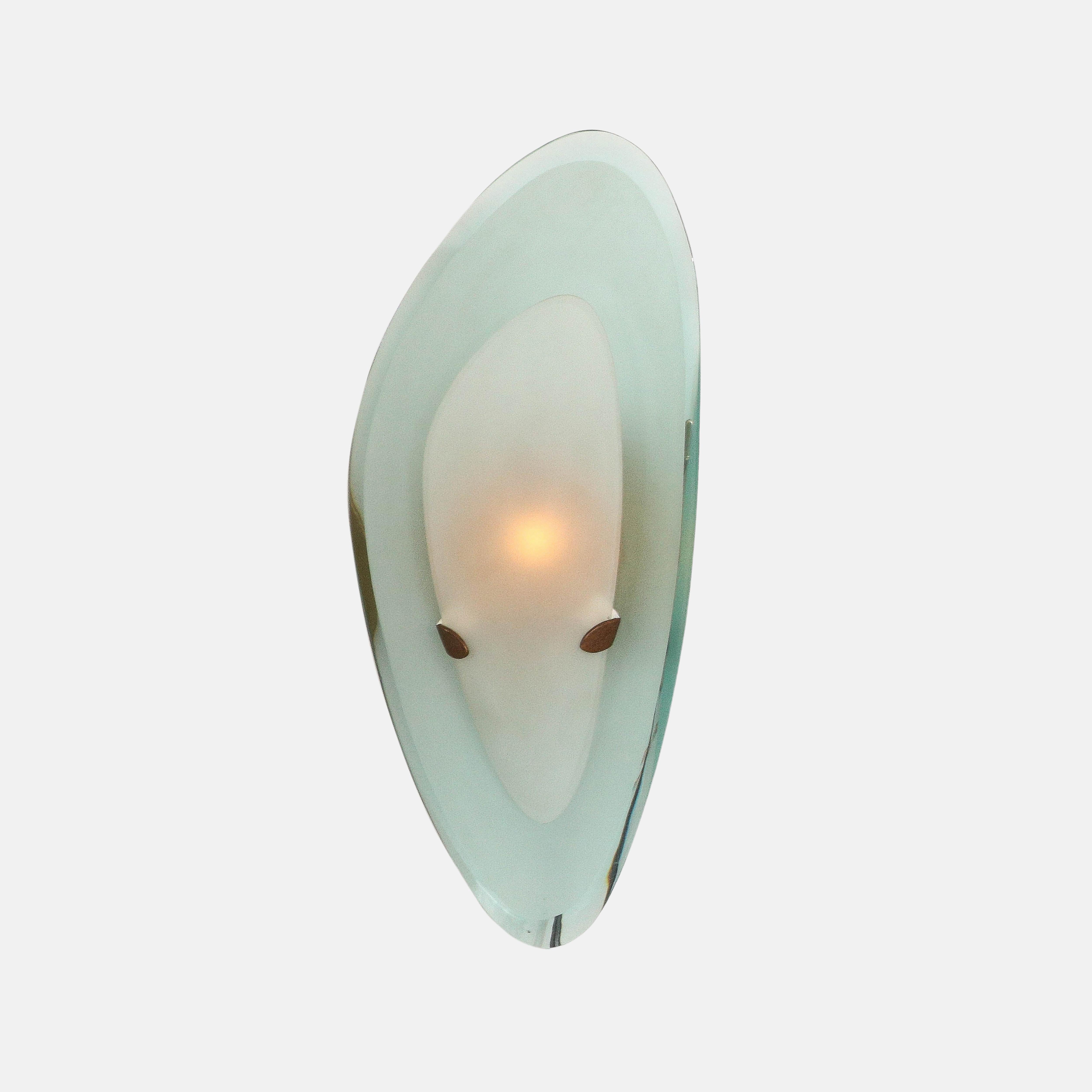 Max Ingrand for Fontana Arte rare exquisite pair of sconces consisting of colored curved and beveled ground glass and smaller curved satin or acid-etched glass shades suspended by brass brackets which are attached to round cylindrical brass