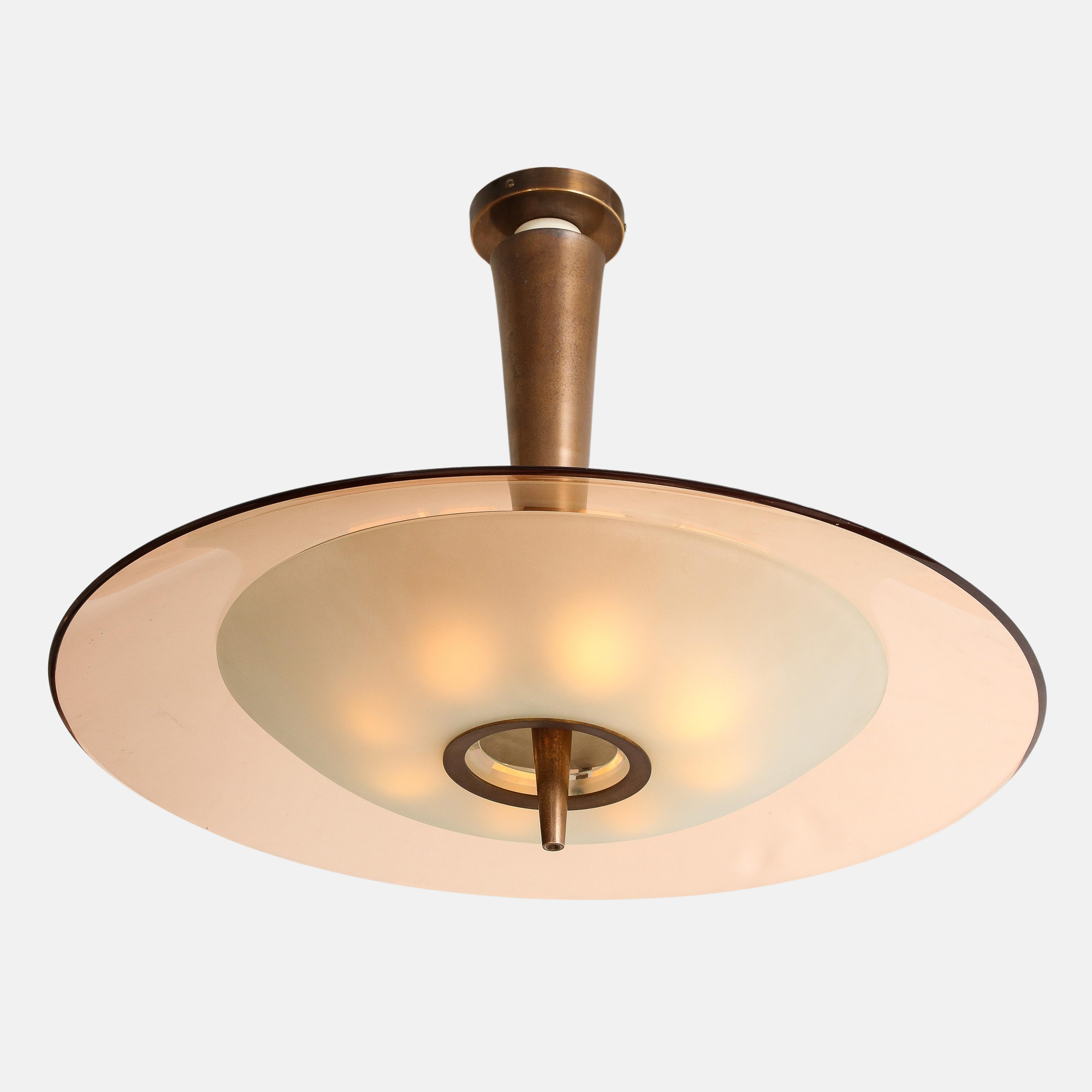 Max Ingrand for Fontana Arte chandelier or pendant light model 1462 consisting of large rose beveled and polished crystal glass disc and smaller frosted glass diffuser mounted on tapering lacquered brass stem.  
This exquisite ceiling light has 8