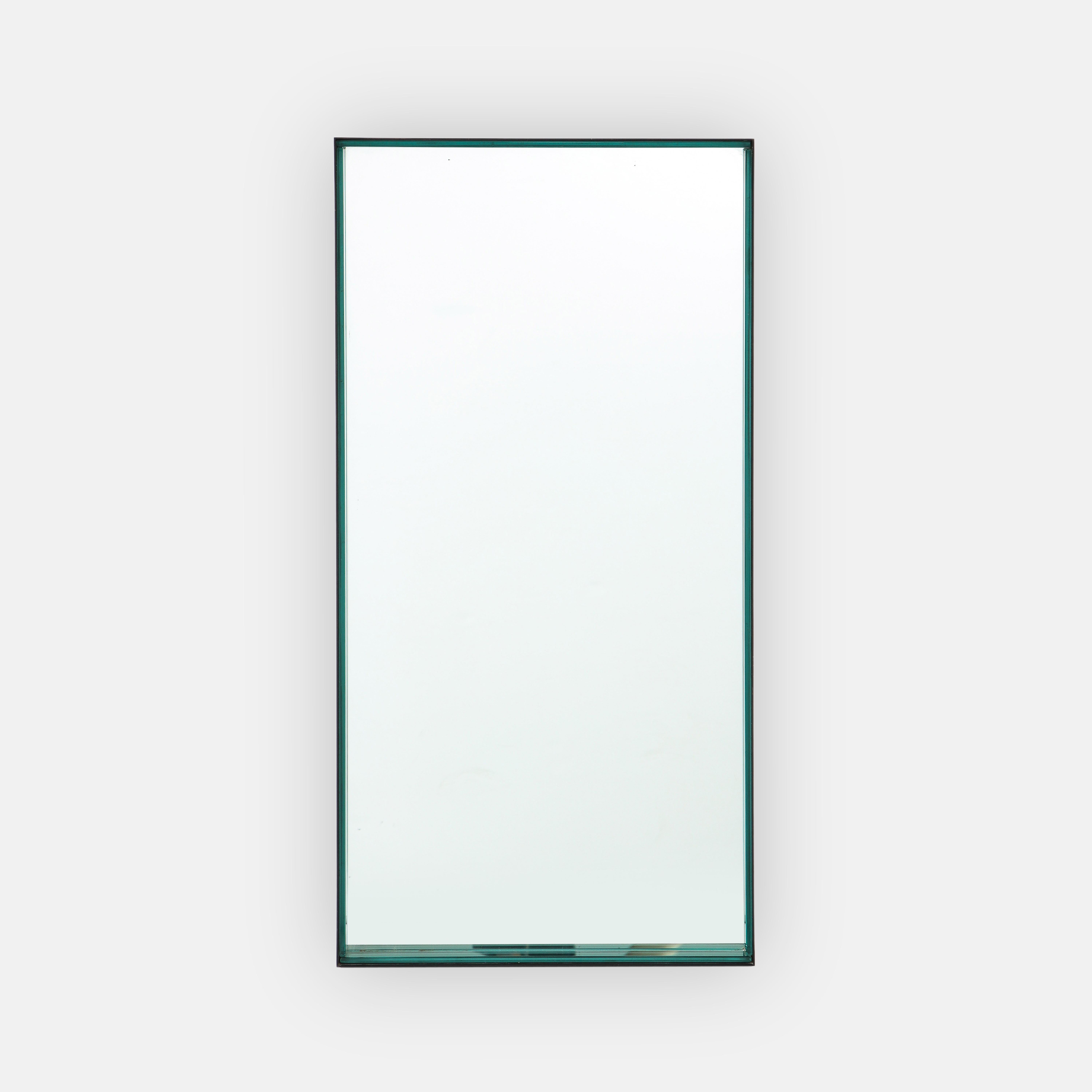 Max Ingrand for Fontana Arte rare rectangular mirror model 1929 with thick strips of green colored glass encased in black enameled metal frame. Balancing a striking contrast of dark metal with exquisite green glass, this modernist mirror exemplifies