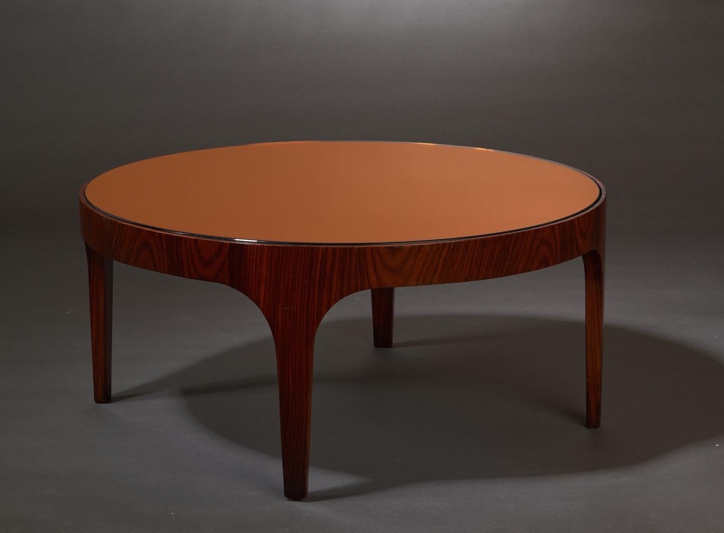 Max Ingrand (1908 - 1969)

A rare and exceptionally pure Model 1774 round coffee table by Max Ingrand for Fontana Arte. In wood with a circular top in burnt umber mirrored glass, resting on an elegantly curved base raised on tapering legs. 

Italy,