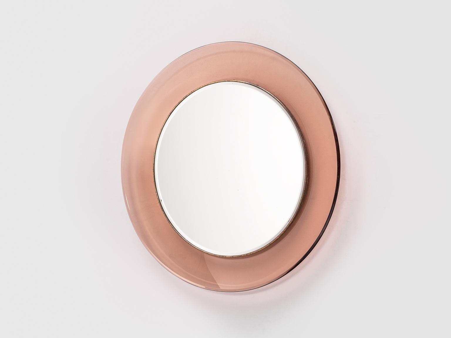 Max Ingrand for Fontana Arte round mirror model '1669', made in glass and mirror, Italy, 1964.

This round mirror is created by Max Ingrand who works a lot with glass. This beautiful mirror is surrounded by a transparent pink glass which is held