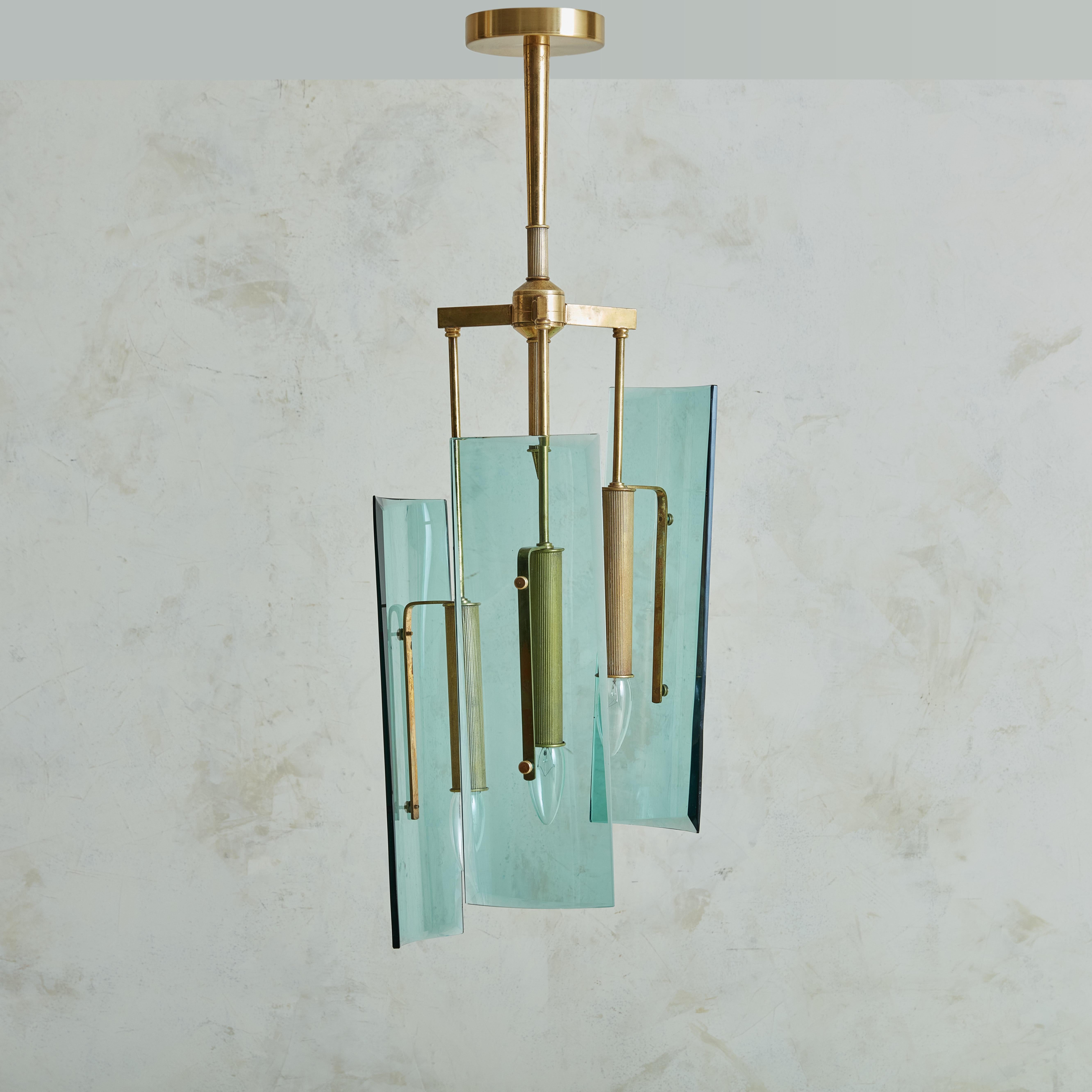 Beautiful Max Ingrand for Fontana Arte style Pendant with brass structure and stunning curved light blue tinted glass shades. The three arms, positioning the light bulbs on different heights diffuse the light in opposite directions creating a bright