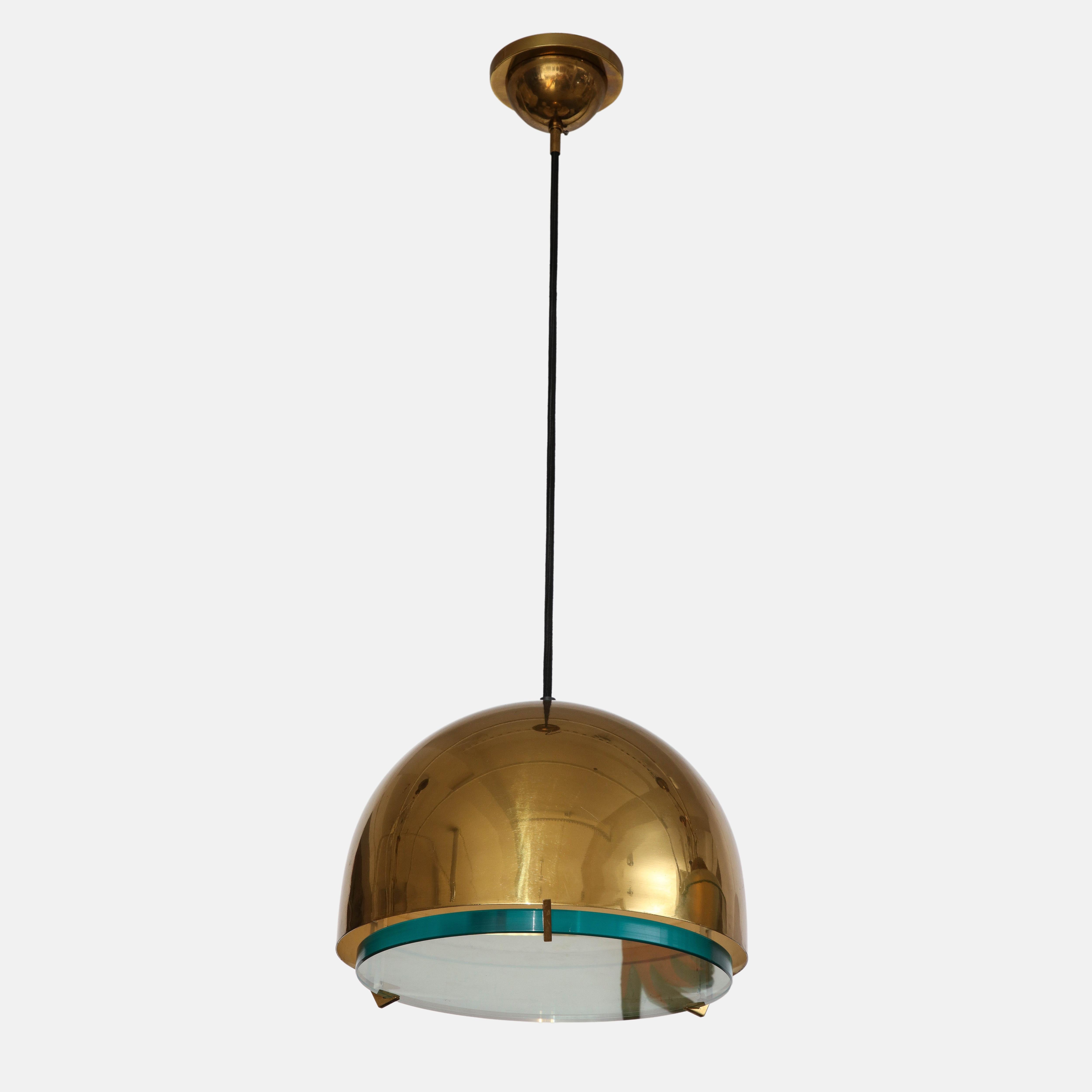 Max Ingrand for Fontana Arte pendant or suspension light model 2409 consisting of dome-shaped brass shade and a thick polished clear crystal glass diffuser held by three brass brackets suspended by thick black silk cord with variable drop on