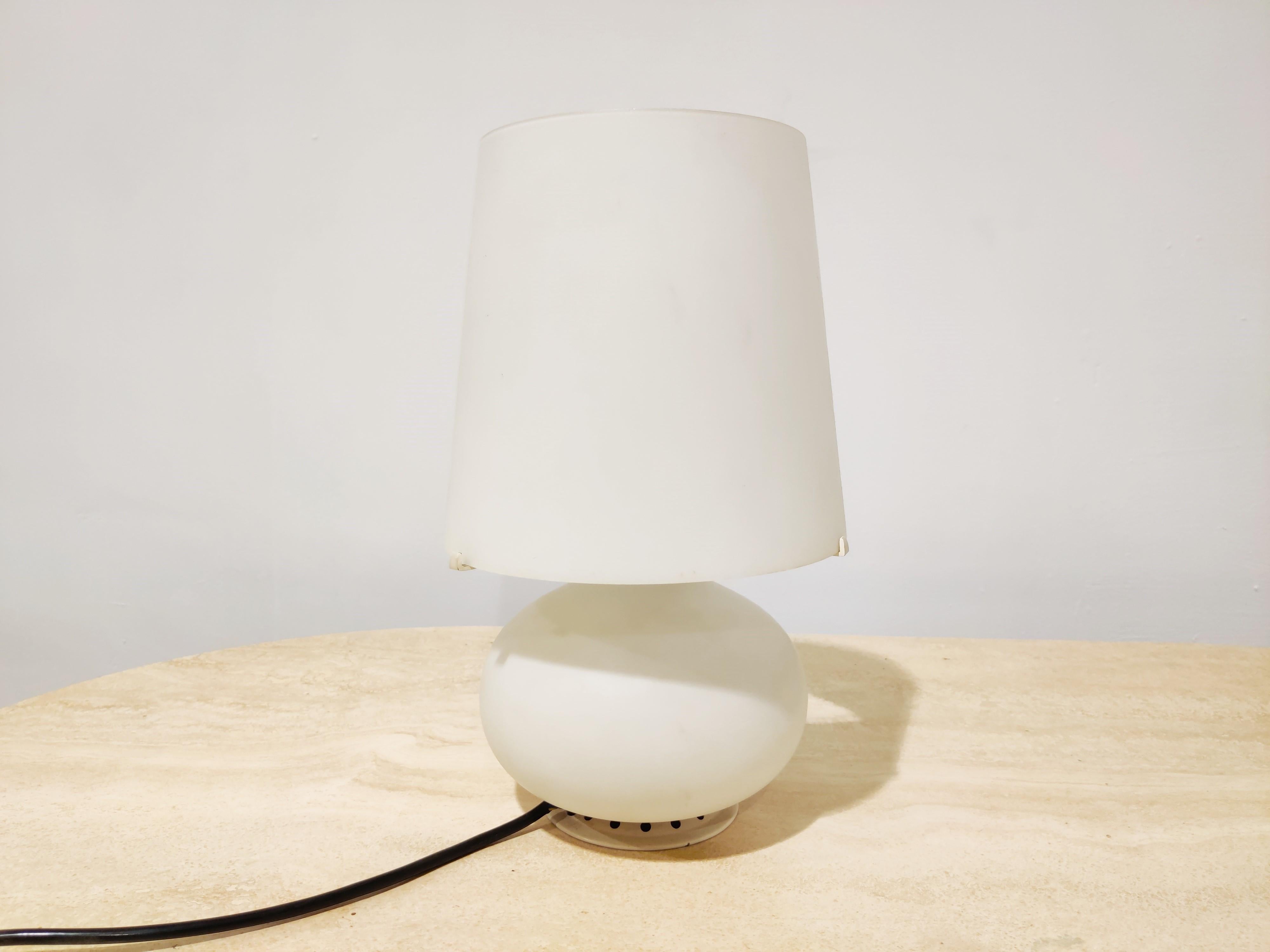 Midcentury table lamp in white glass designed by Max Ingrand for Fontana Arte in the 1950s 

This one is a vintage example and we would date it between 1960s-1970s 

This lamp has been a popular design because it is still being produced
