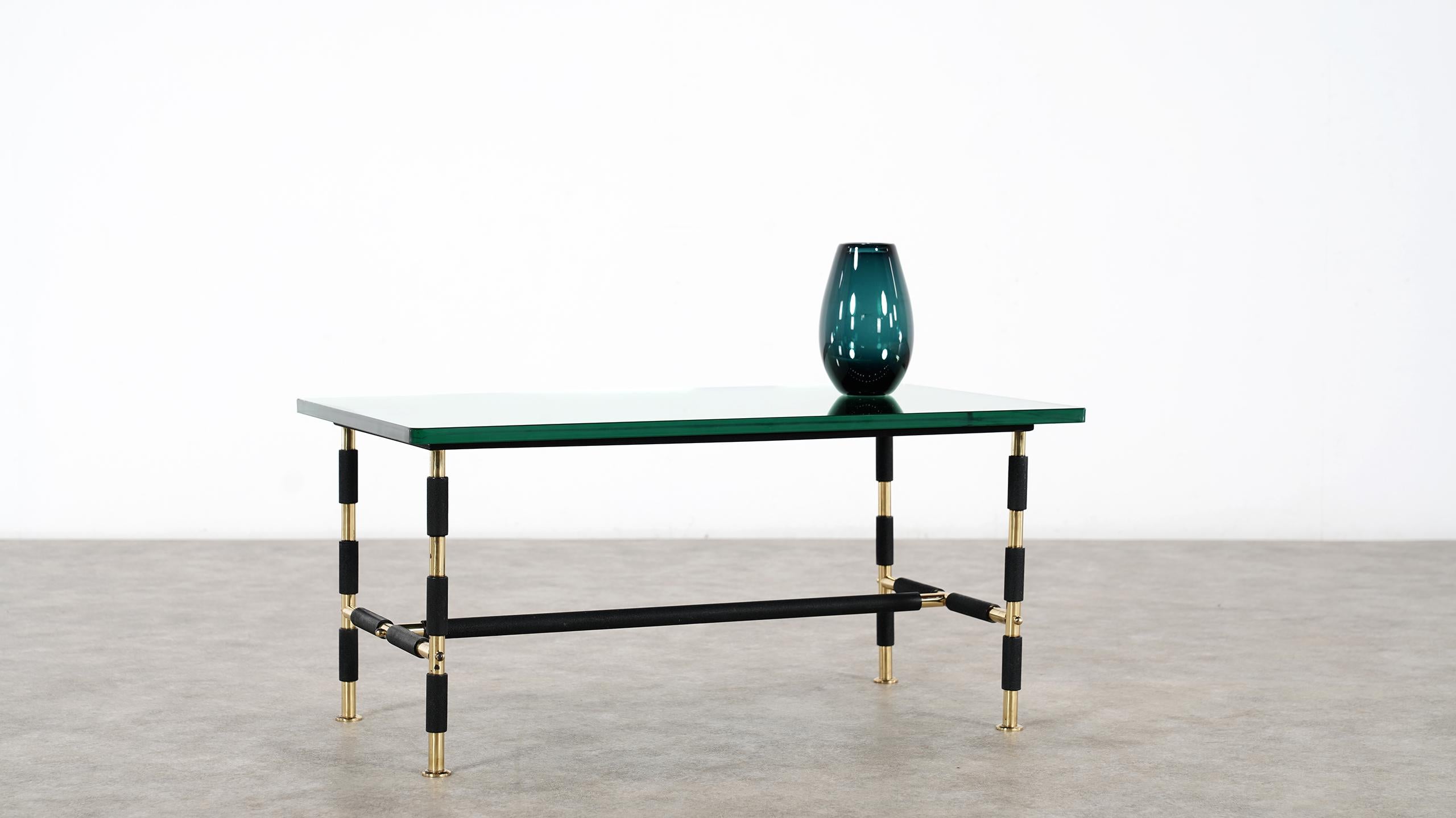 Max Ingrand for Fontana Arte in 1955 -
coffee or cocktail table model 1736 composed of a polished brass and aged steel structure and available with its beautiful original thick and rounded mirror glass top.
(One corner of the table is a little