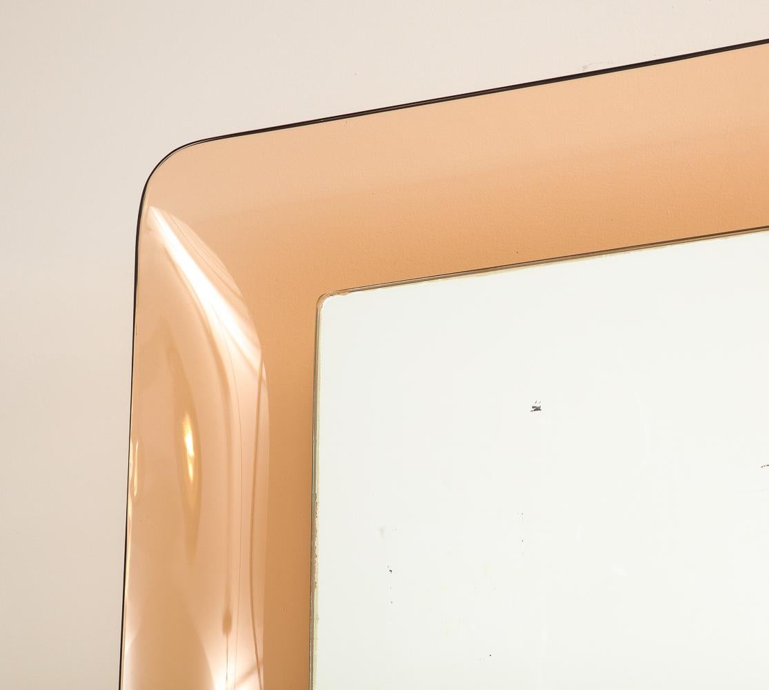 Rare Rectangular Mirror #2273 by Max Ingrand for Fontana Arte. Colored glass, mirrored glass, wood. Mirror framed by rose colored, curved glass with center mirrored panel.