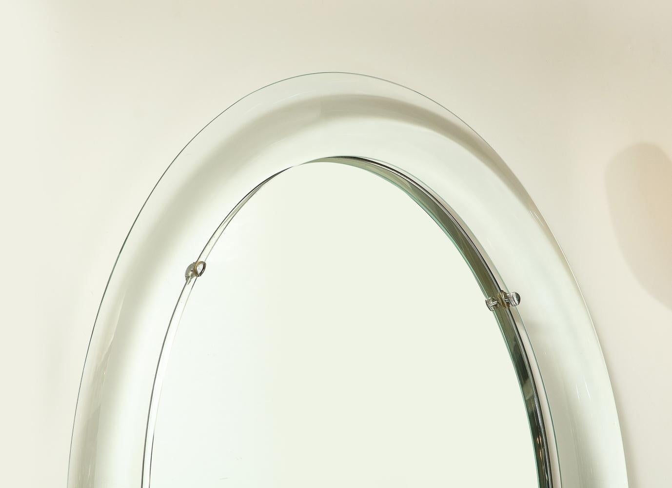 Oval Mirror by Max Ingrand for Fontana Arte. Beveled glass, mirror, nickeled brass, steel. Maker's stickers to back of mirrored glass panel. A rare model.