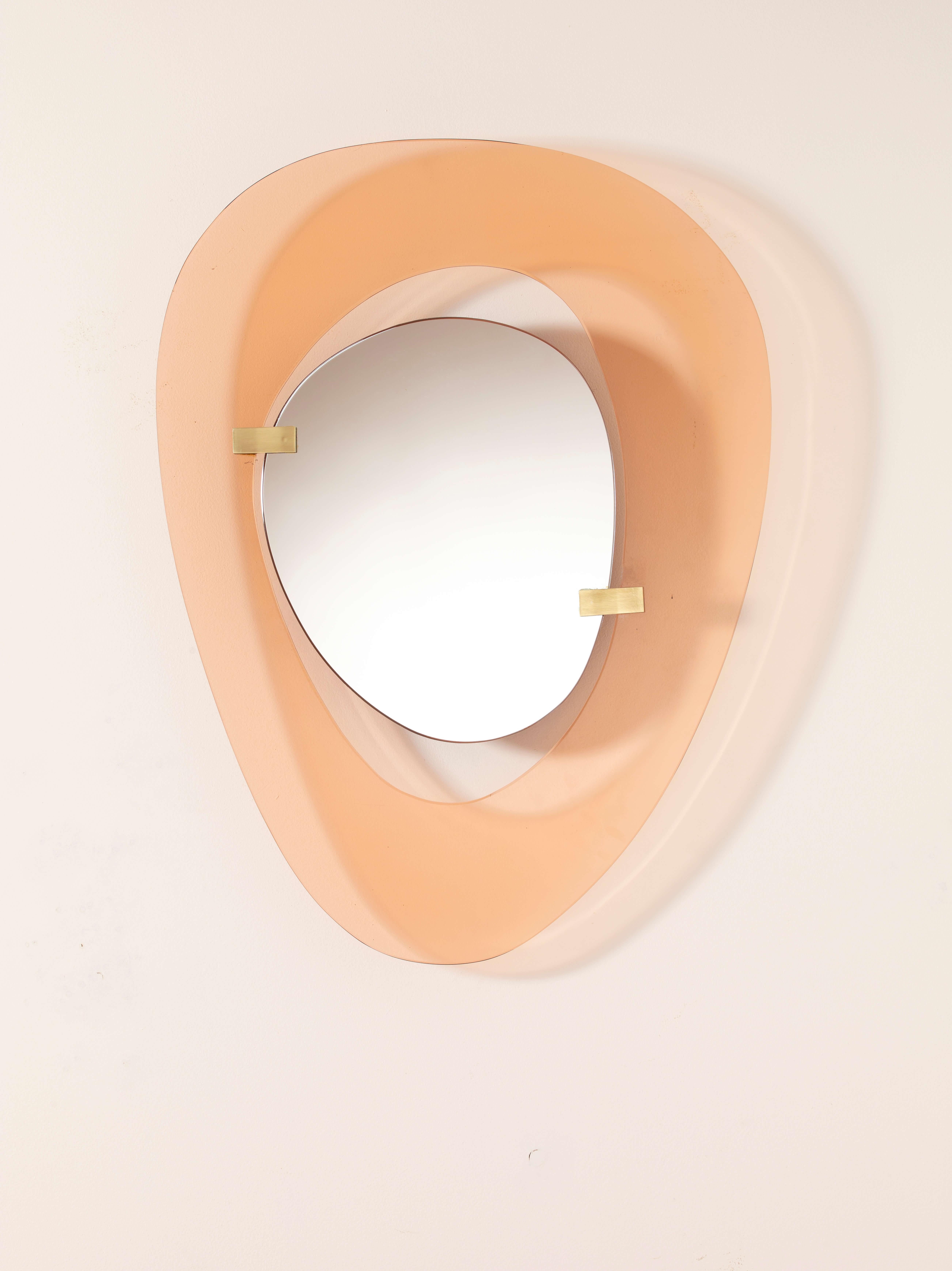 A mirror with crystal glass frame and brass mounts, produced by FontanaArte, designed by Max Ingrand, Italy, 1960s

A rare mirror designed by Max Ingrand for FontanaArte, featuring an asymmetrical frame in glossy orange/pink glass that delicately