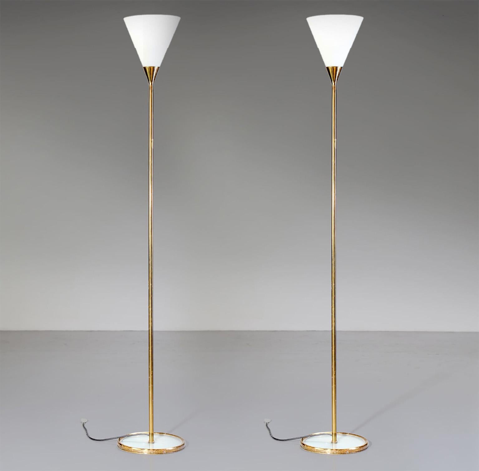 Rare pair of fine Fontana Arte floor lamps mod. 2003 designed by Max Ingrand in 1950s for Fontana Arte in Milano.
The pure line of the insert between brass stand and the glass reflector cone characterize this special design as ever modern and