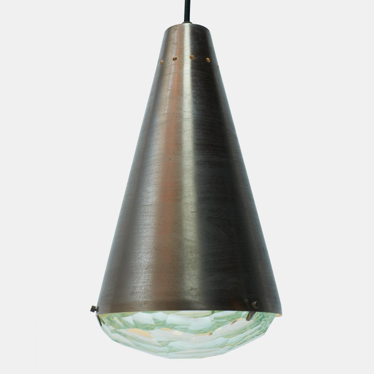 A bronzed metal pendant lamp designed by Max Ingrand for Fontana Arte, Italy, circa 1960. Model #1995. Production ceased in 1964. Lens is of thick crystalline glass.
Literature : 