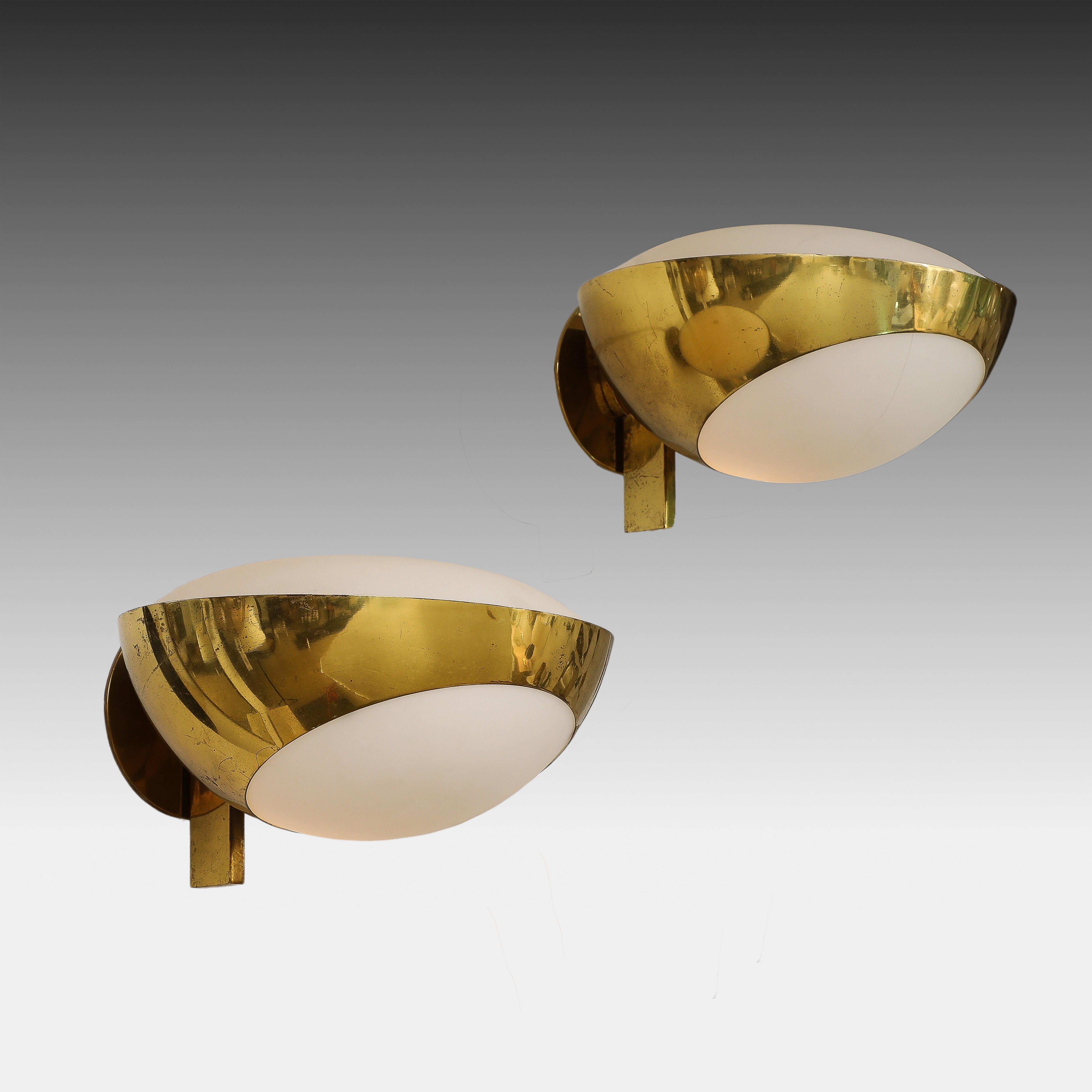Max Ingrand for Fontana Arte rare pair of large model 1963 sconces, Italy, circa 1960. These exquisite sconces consist of brass structures which hold opaline or frosted glass diffusers below and above. This model exudes an elegance and simplicity in