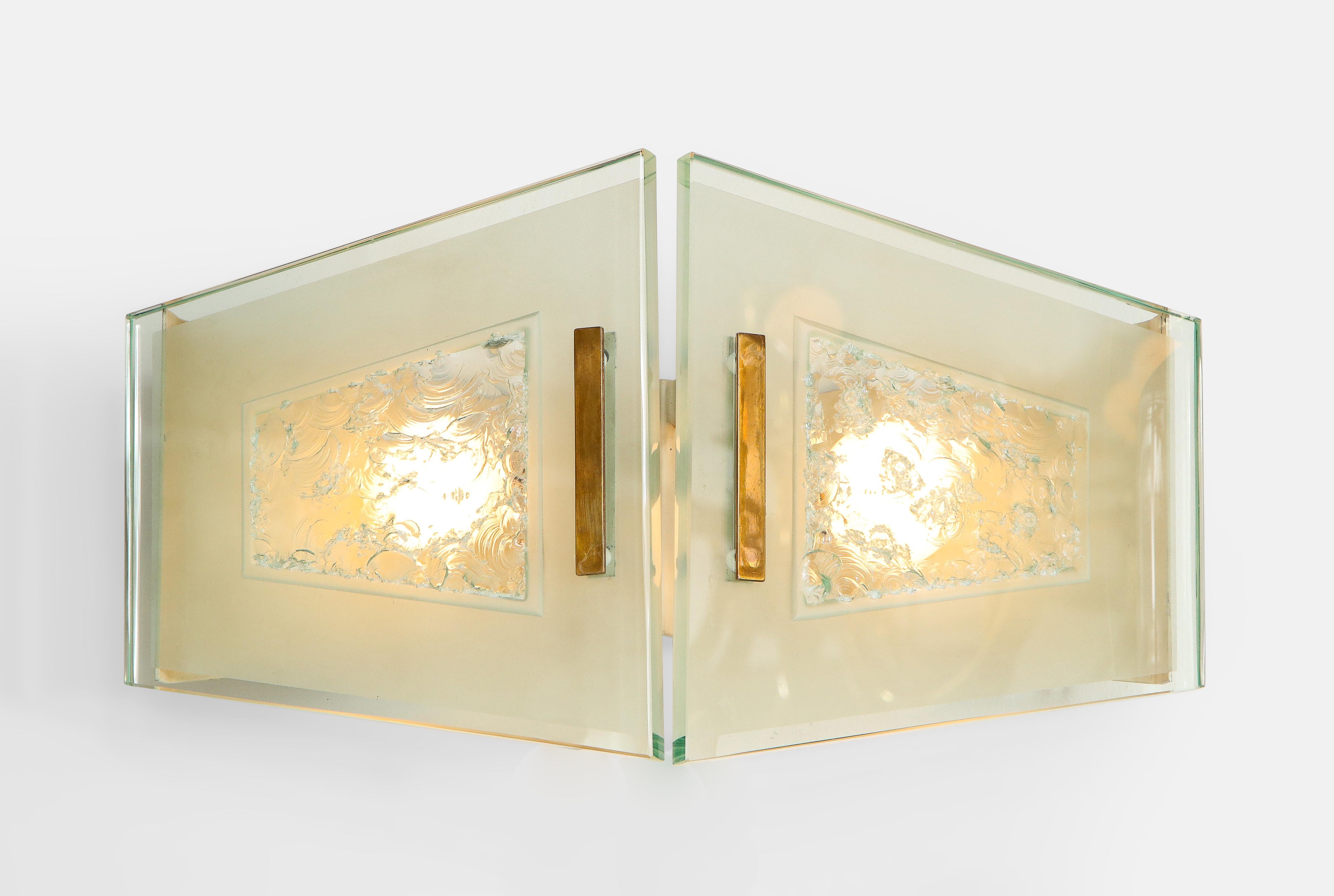 Max Ingrand for Fontana Arte rare pair of sconces with two plates of chiseled, acid-etched, and polished glass with polished brass mounts on painted aluminum backplates. Newly rewired to U.S. standards.

Literature:
Fontana Arte sales catalogue,