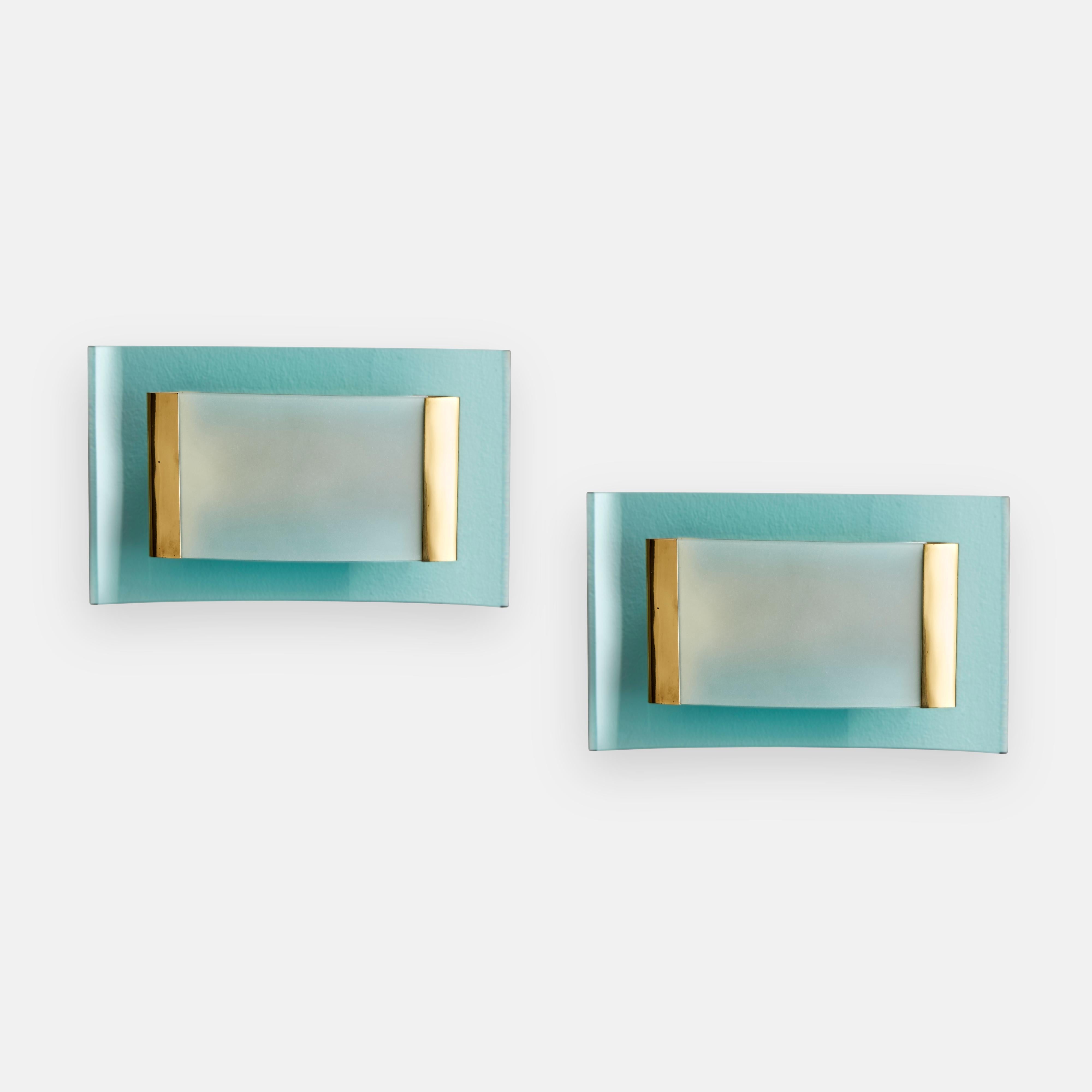 Max Ingrand for Fontana Arte rare and exquisite pair of modernist sconces or wall lights with light blue bent cut and bevelled glass and smaller central bent frosted glass held by brass fittings. 

Literature:
Illuminazione Arredamento Cristalli