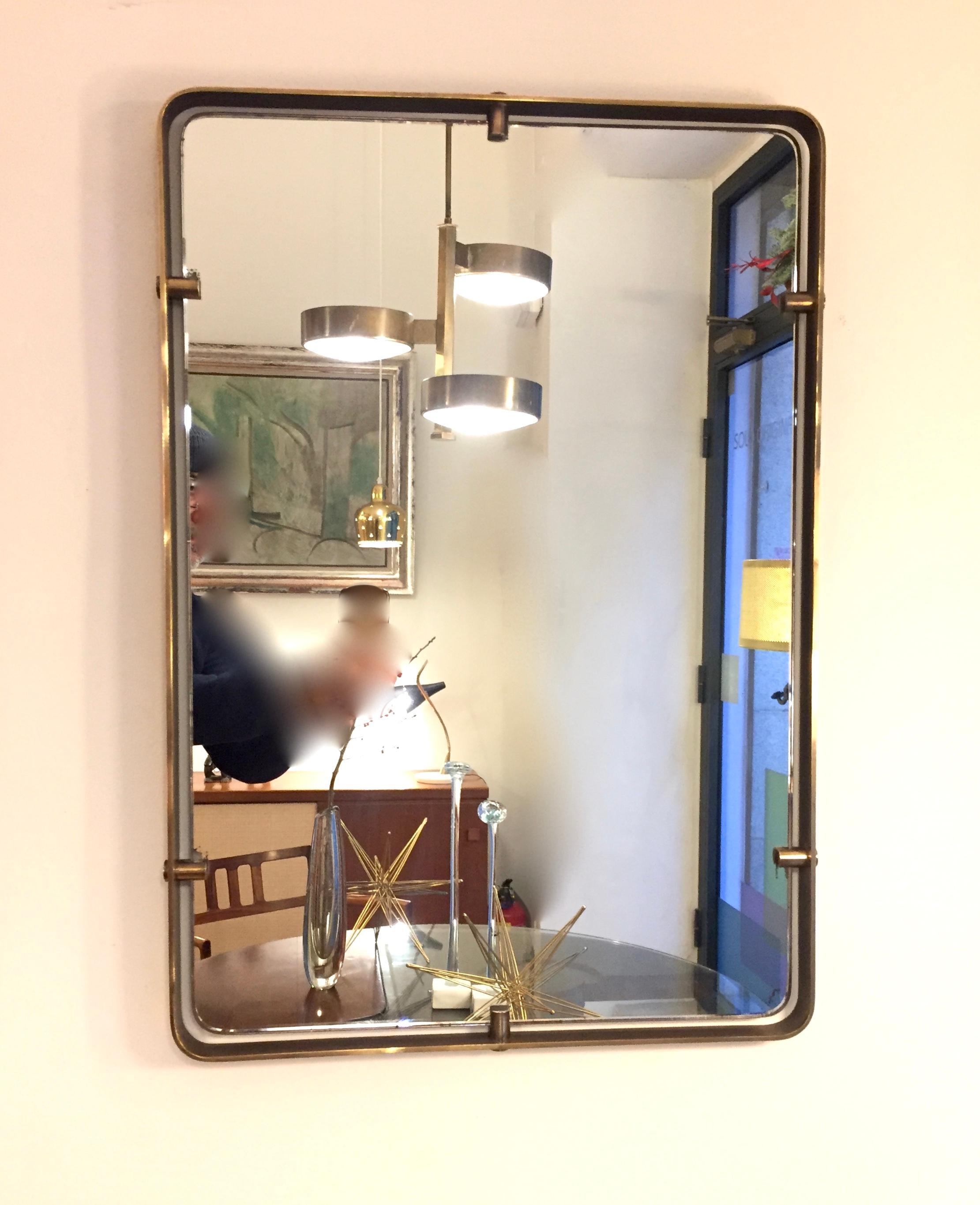 A luxury mirror designed by Max Ingrand and edited in 1950 by Fontana Arte,Brass frame with six brass clips supporters , Murano glass , Very good condition.High standard collection piece recommendable for luxury interiors decoration.